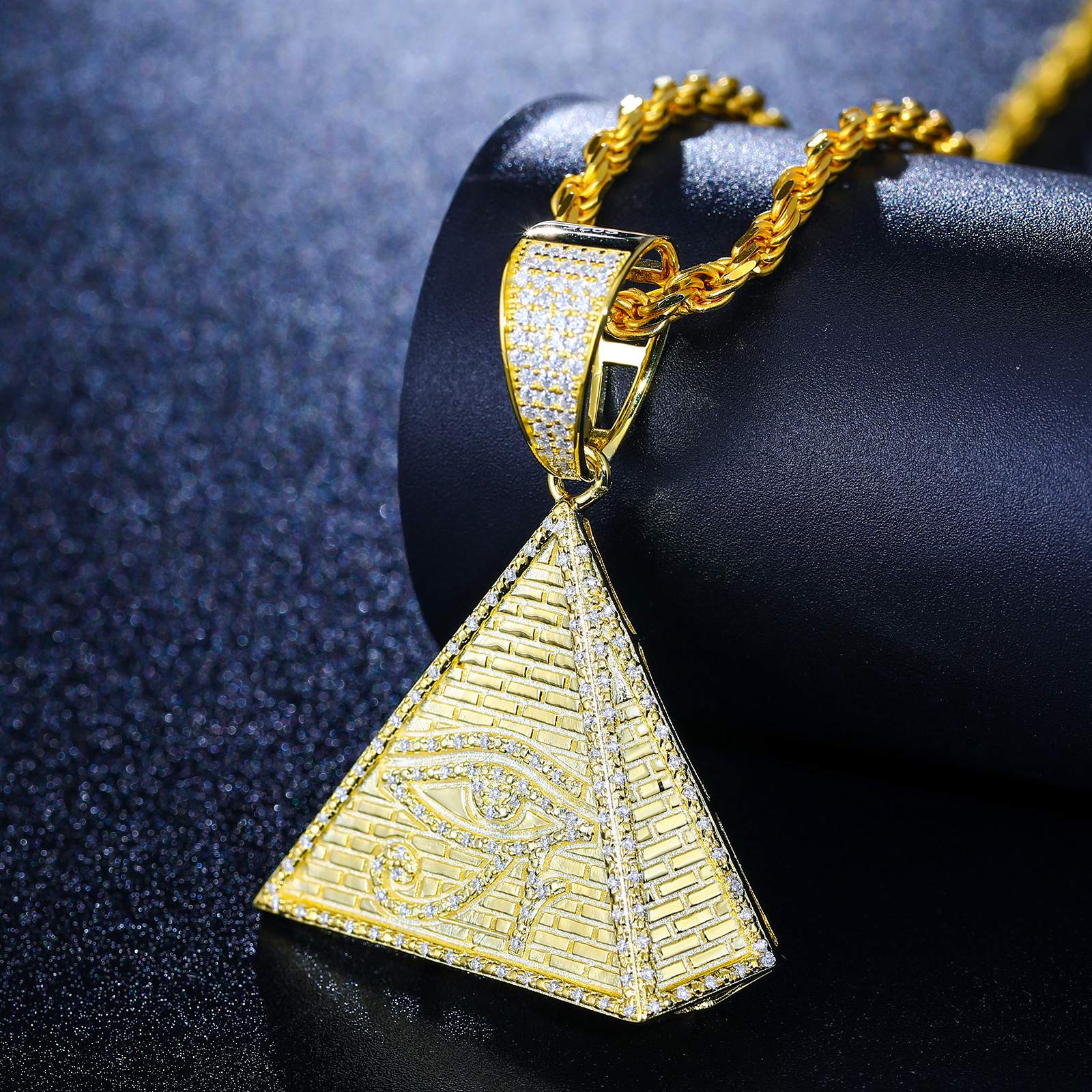 Art-directed flatlay: Gold pyramid pendant with evil eye engraving - 38 VVS moissanites set in sacred geometry | ISO 9227 corrosion-proof