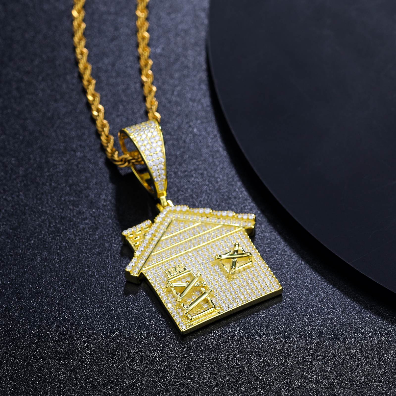 Art-directed flatlay: Gold trap house pendant on marble - 48 VVS moissanites per facade | ISO 9227 corrosion-proof certification