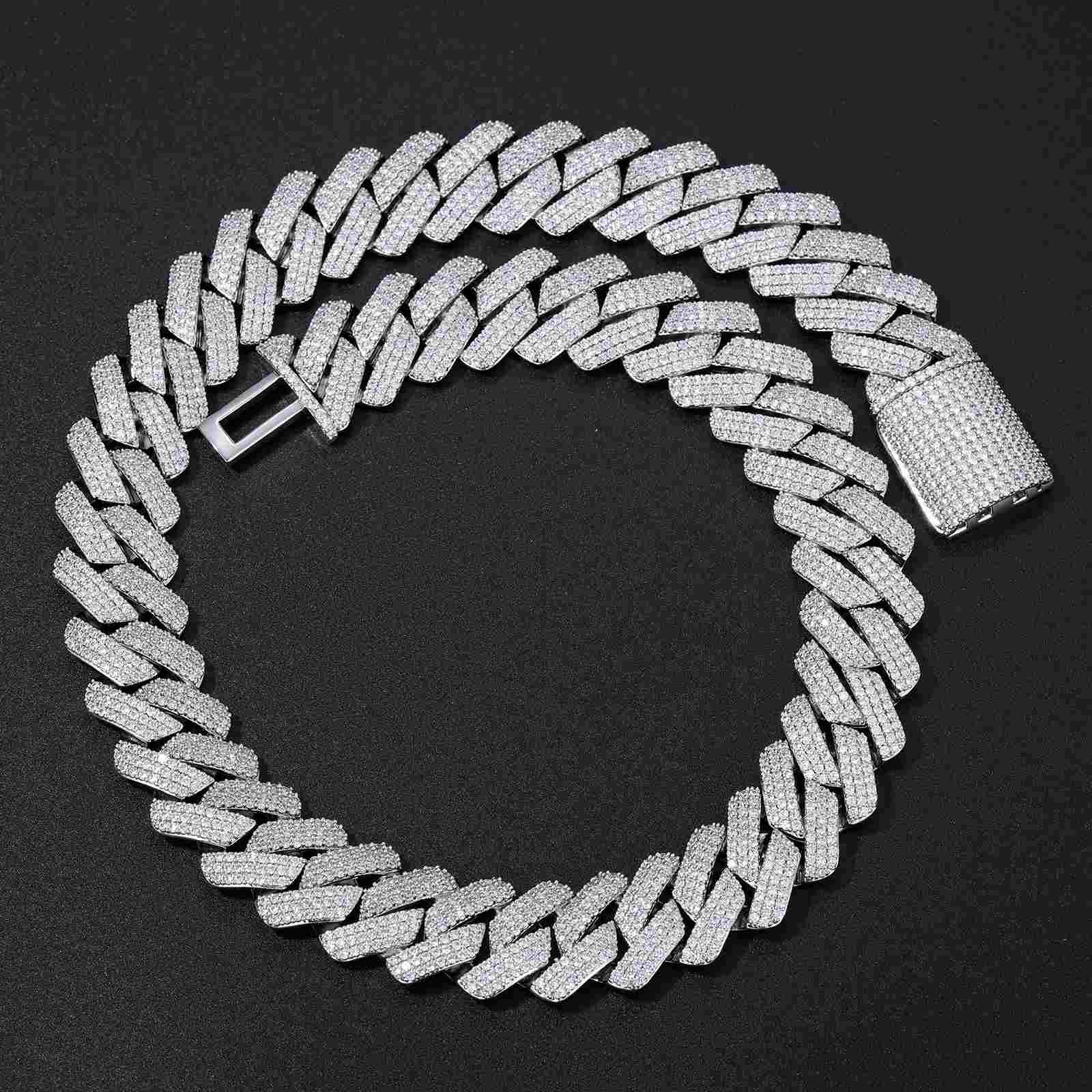 Angled view of the 20mm Cuban Link Chain under dramatic lighting, highlighting the prong-set CZ diamonds and polished 925 silver links for streetwear luxury