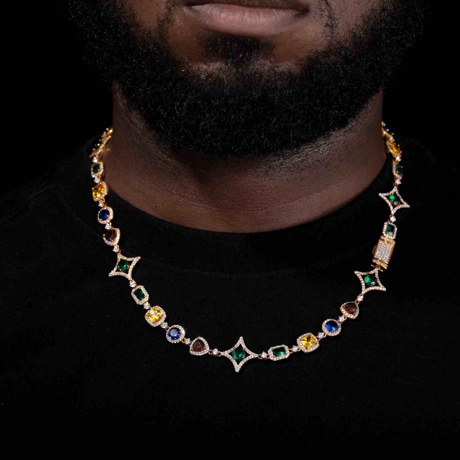 Gold-plated Star Halo Chain layered with thick Cuban links on a male model, shot in a graffiti alley for urban authenticity