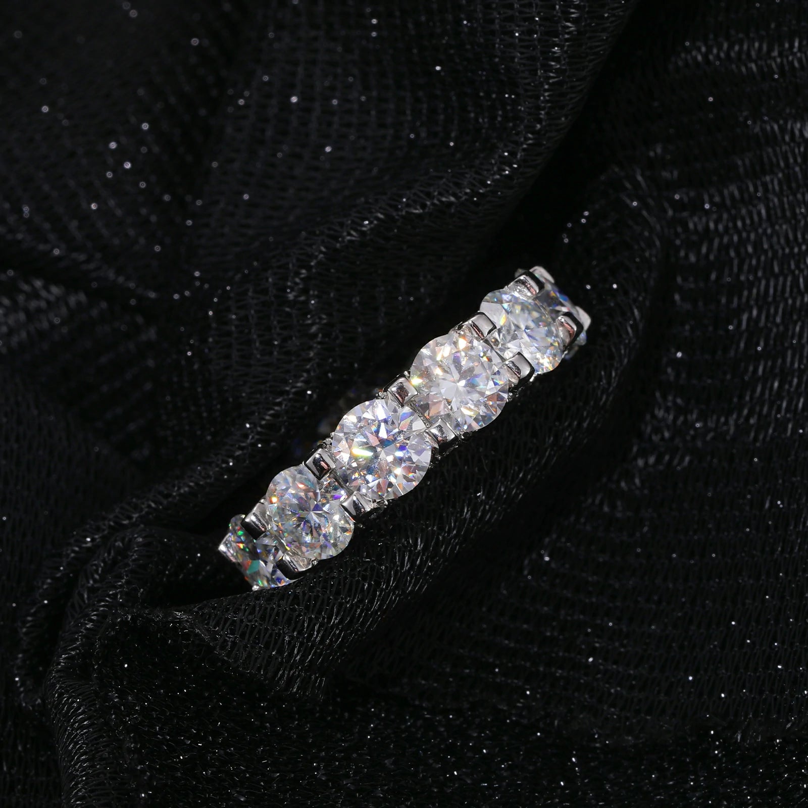Front close-up of white gold moissanite cluster ring, showing precision-set stones and rose-gold-plated prongs for maximum sparkle.