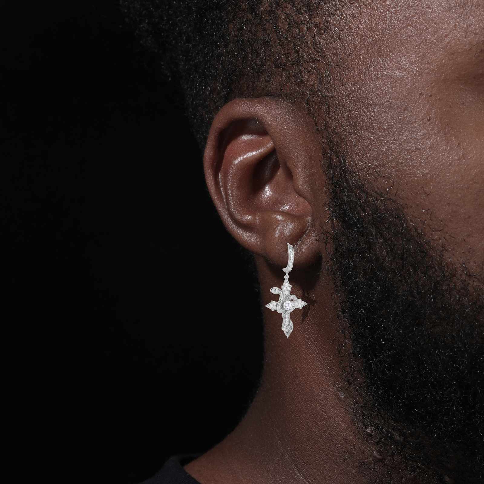 Stylish model wearing gold snake wrap cross earrings, highlighting elegance and movement for everyday or special occasions.