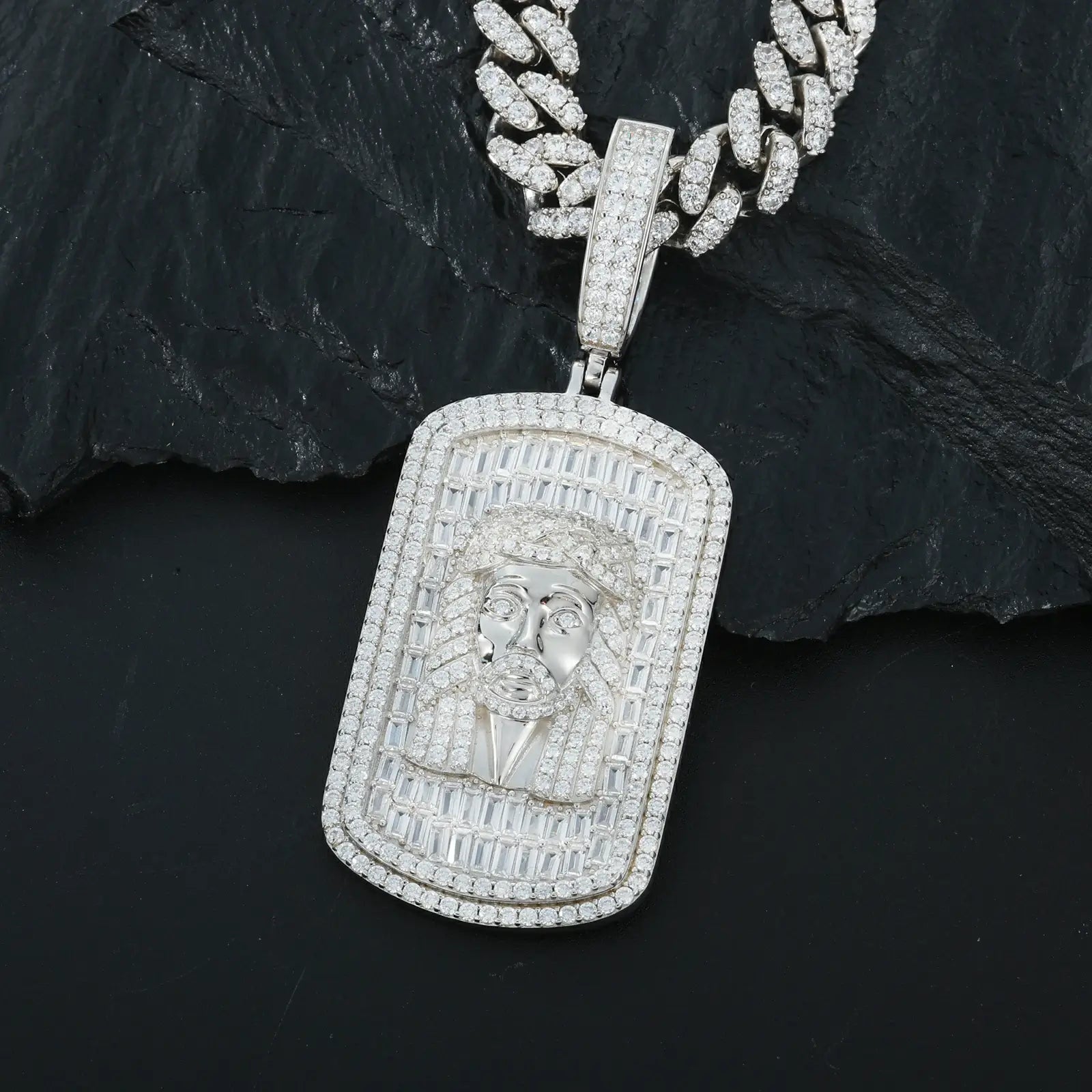 Close-up white gold 925 sterling silver baguette moissanite Jesus dog tag pendant on black table — showcasing baguette moissanite sparkle & Jesus design details