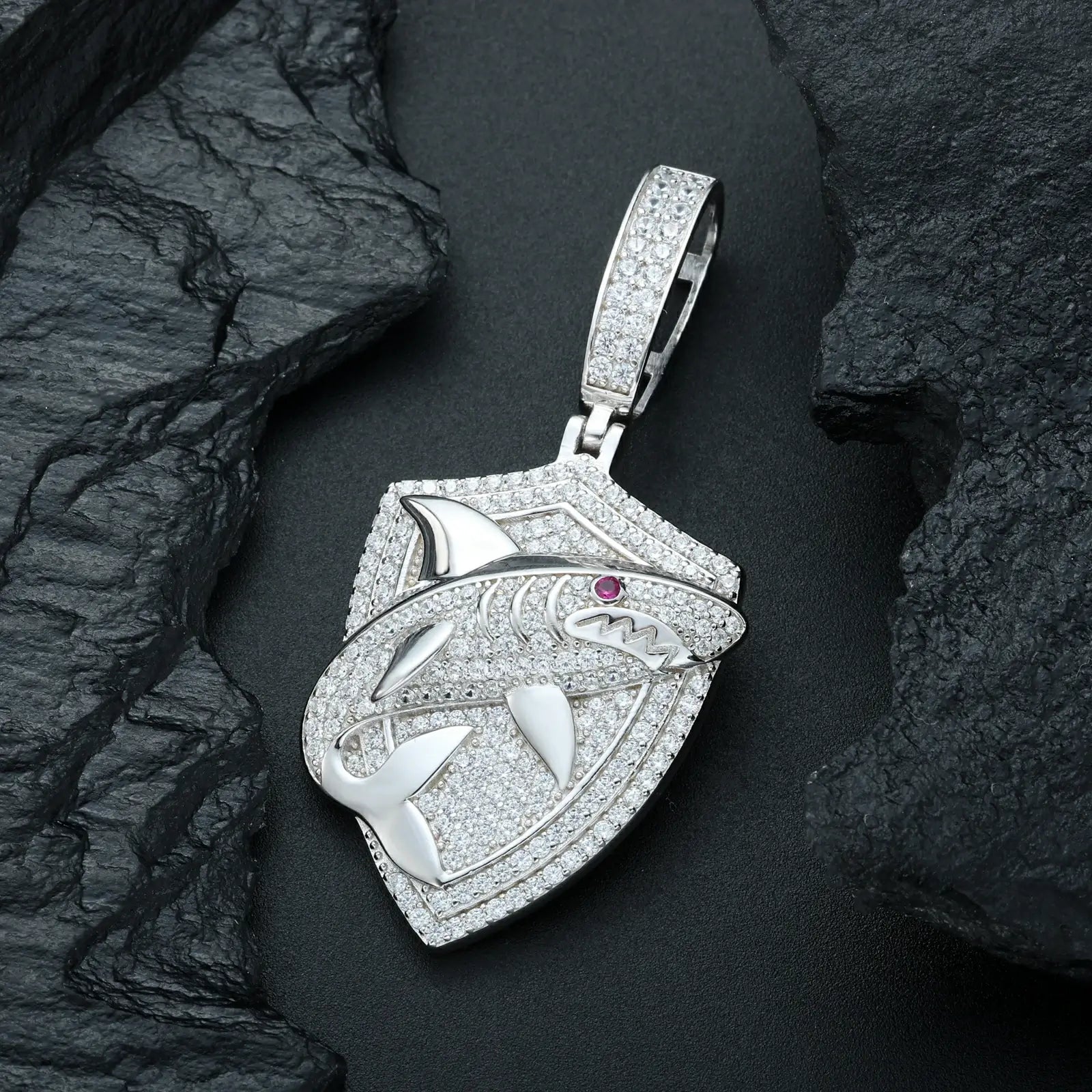 Close-up white gold 925 sterling silver moissanite shark shield pendant on black table — showcasing moissanite sparkle & shark design details