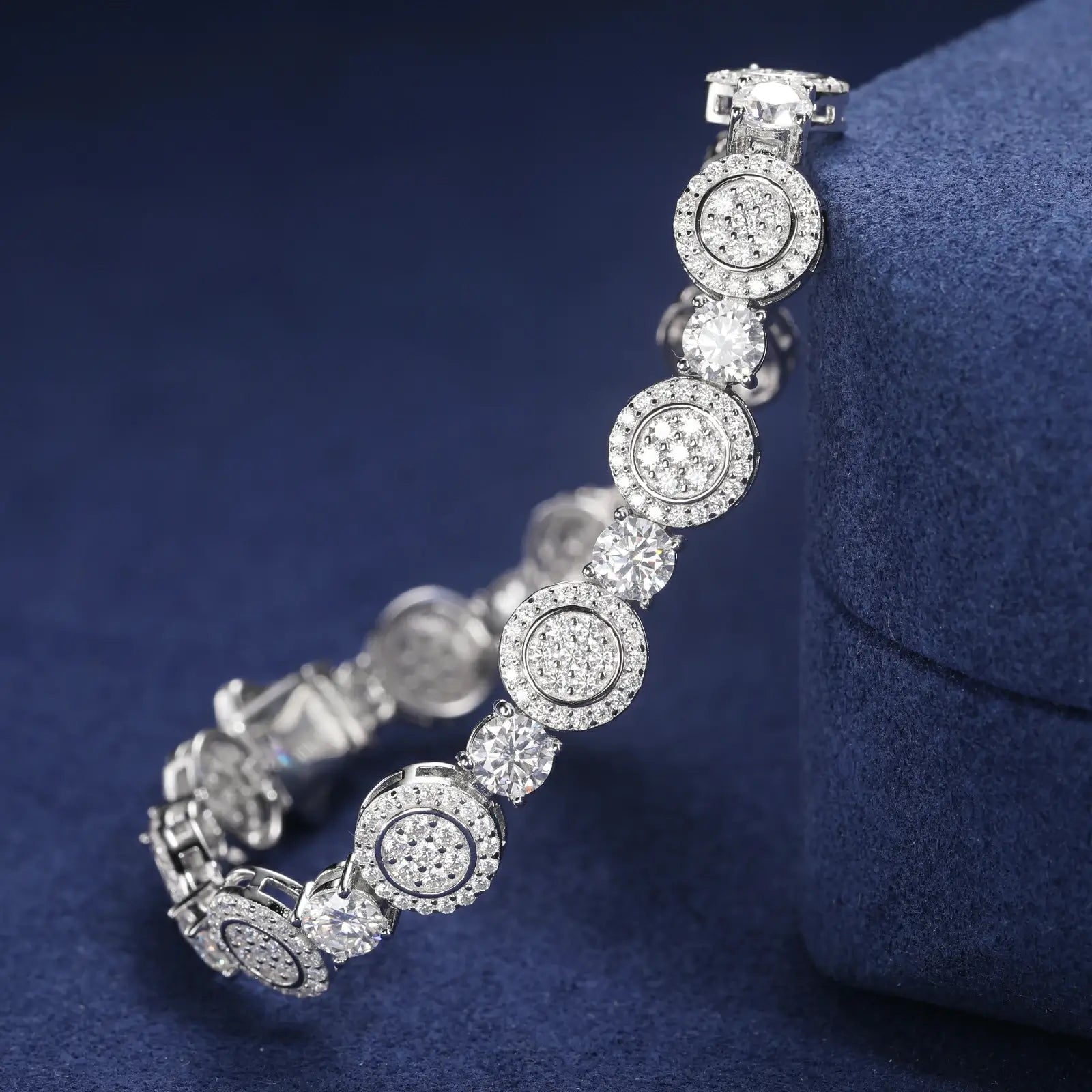 Close-up of 9mm white gold 925 sterling silver moissanite concentric circles tennis bracelet chain on blue table — highlighting moissanite detailing