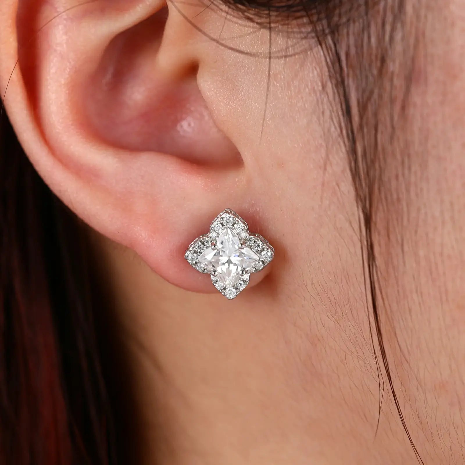 Female model wearing white gold 925 sterling silver lily cut moissanite star stud earrings — hypoallergenic 925 silver, elegant star motif, moissanite detail for refined daily style