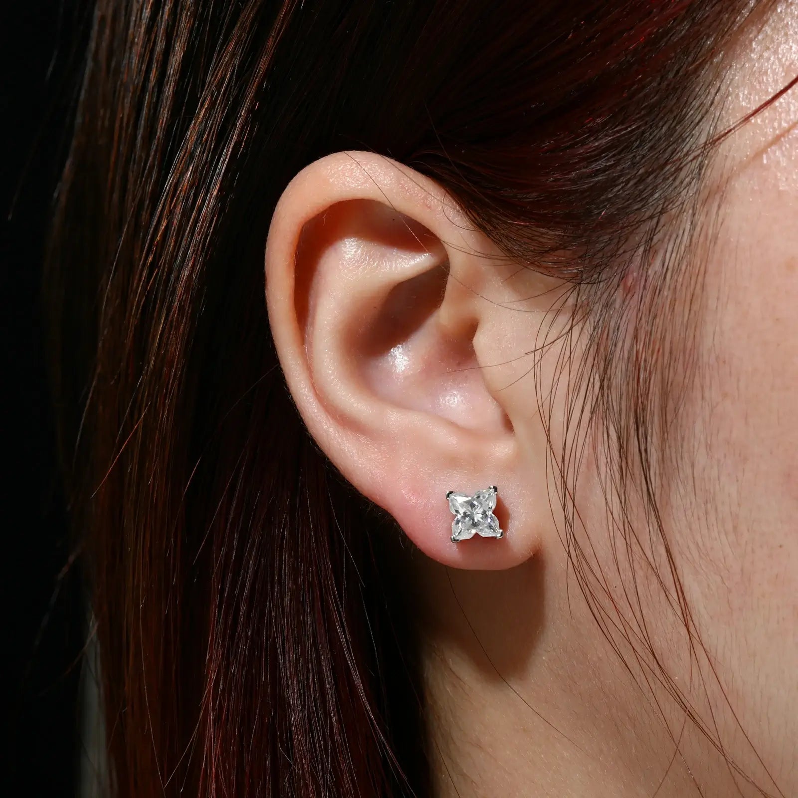 Female model wearing white gold 925 sterling silver lily cut moissanite stud earrings — hypoallergenic 925 silver, unique lily-cut design, moissanite fire for daily & formal style
