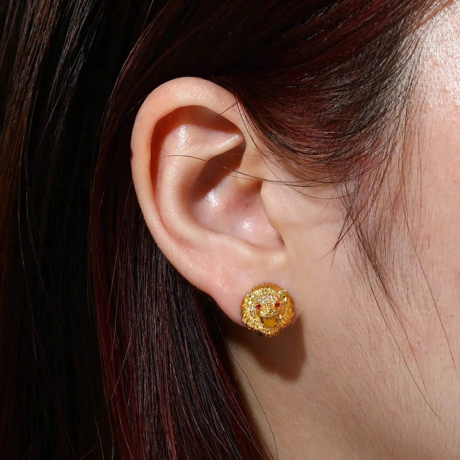 Female model wearing yellow gold 925 sterling silver moissanite little lion stud earrings — hypoallergenic 925 silver, bold lion motif, moissanite fire for edgy daily style