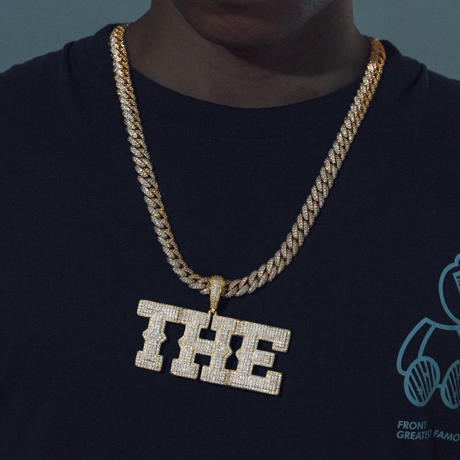 Gold 925 sterling silver moissanite custom spine letter name pendant on black outfit — everyday wearability, hip-hop style, moissanite sparkle, 925 silver comfort