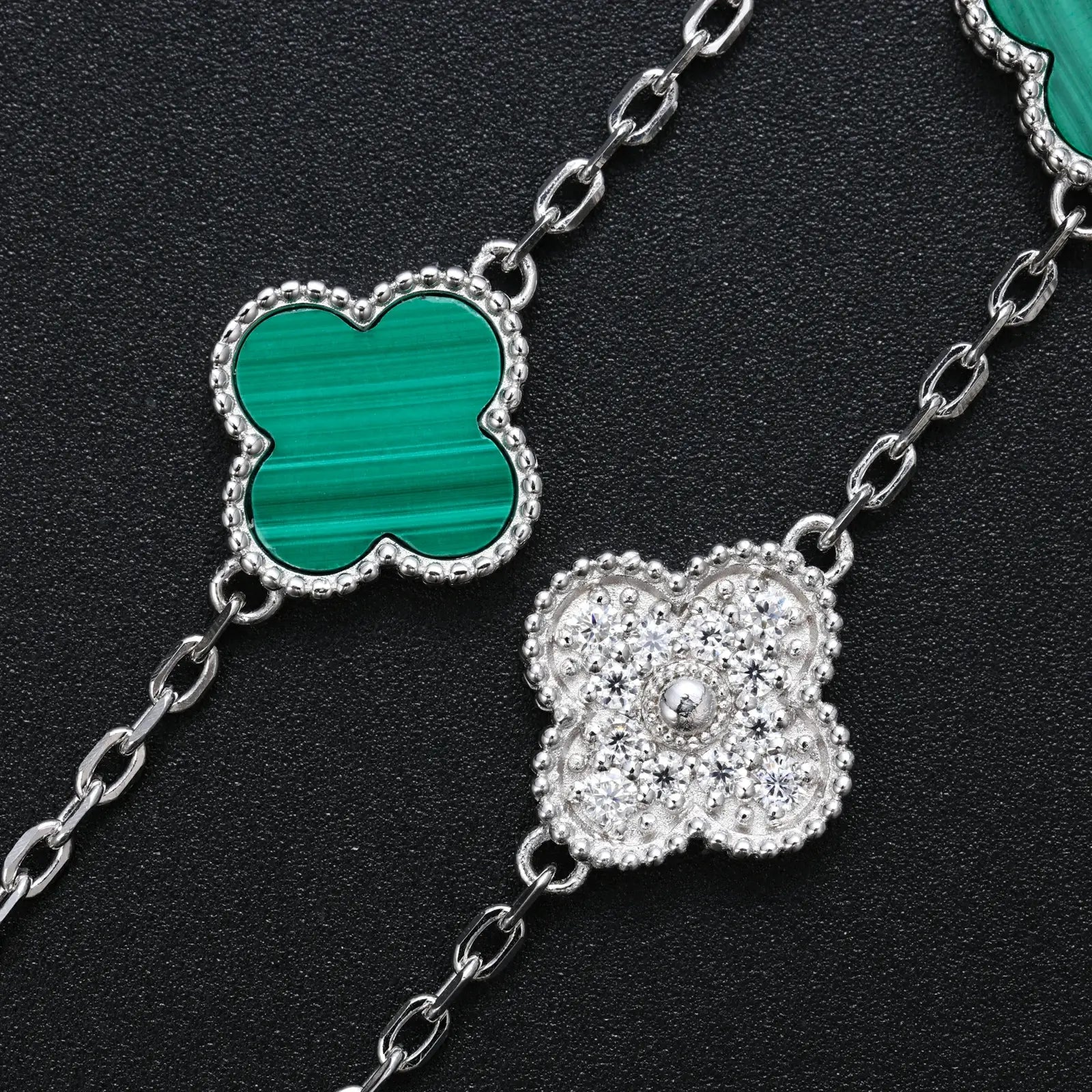 Close-up of malachite & moissanite 5 clover bracelet 925 sterling silver on black background — showcases floral craftsmanship, moissanite detailing, 925 silver build