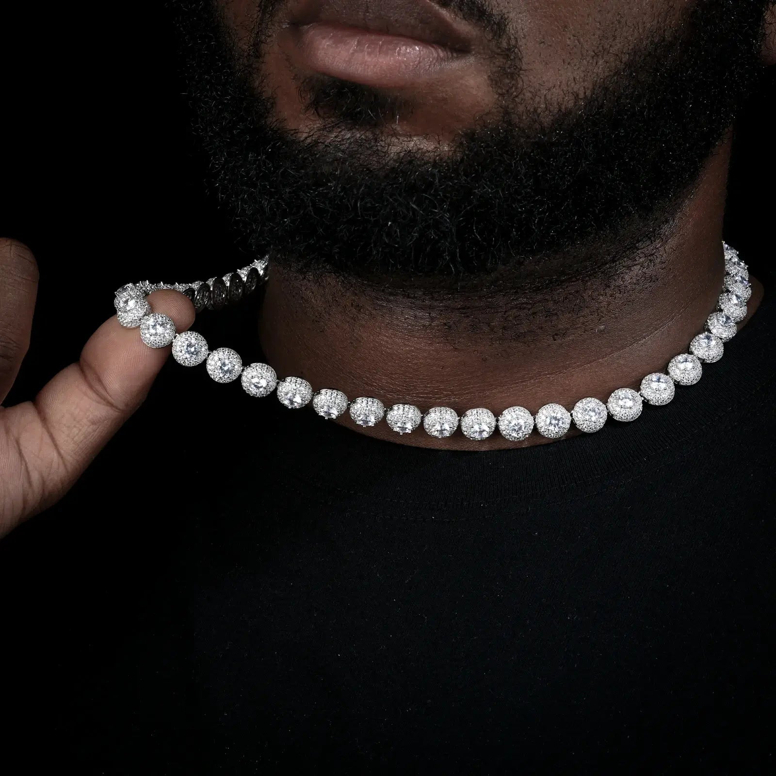 Male model holding white gold 10mm 925 sterling silver moissanite round halo tennis chain — emphasizes round halo craftsmanship, iced-luxury trend, durable 925 silver