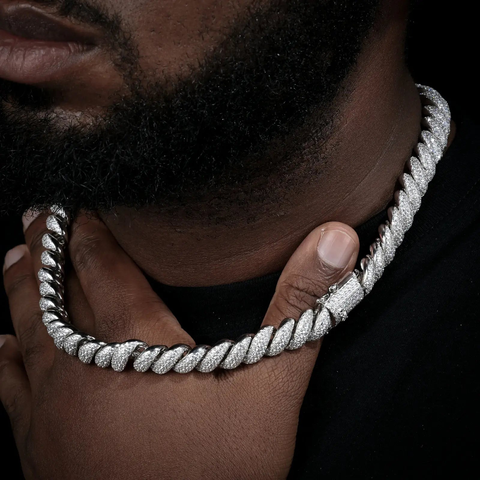 Male model holding white gold 12mm 925 sterling silver moissanite hemp rope chain — emphasizes texture and craftsmanship, iced-luxury trend, durable 925 silver