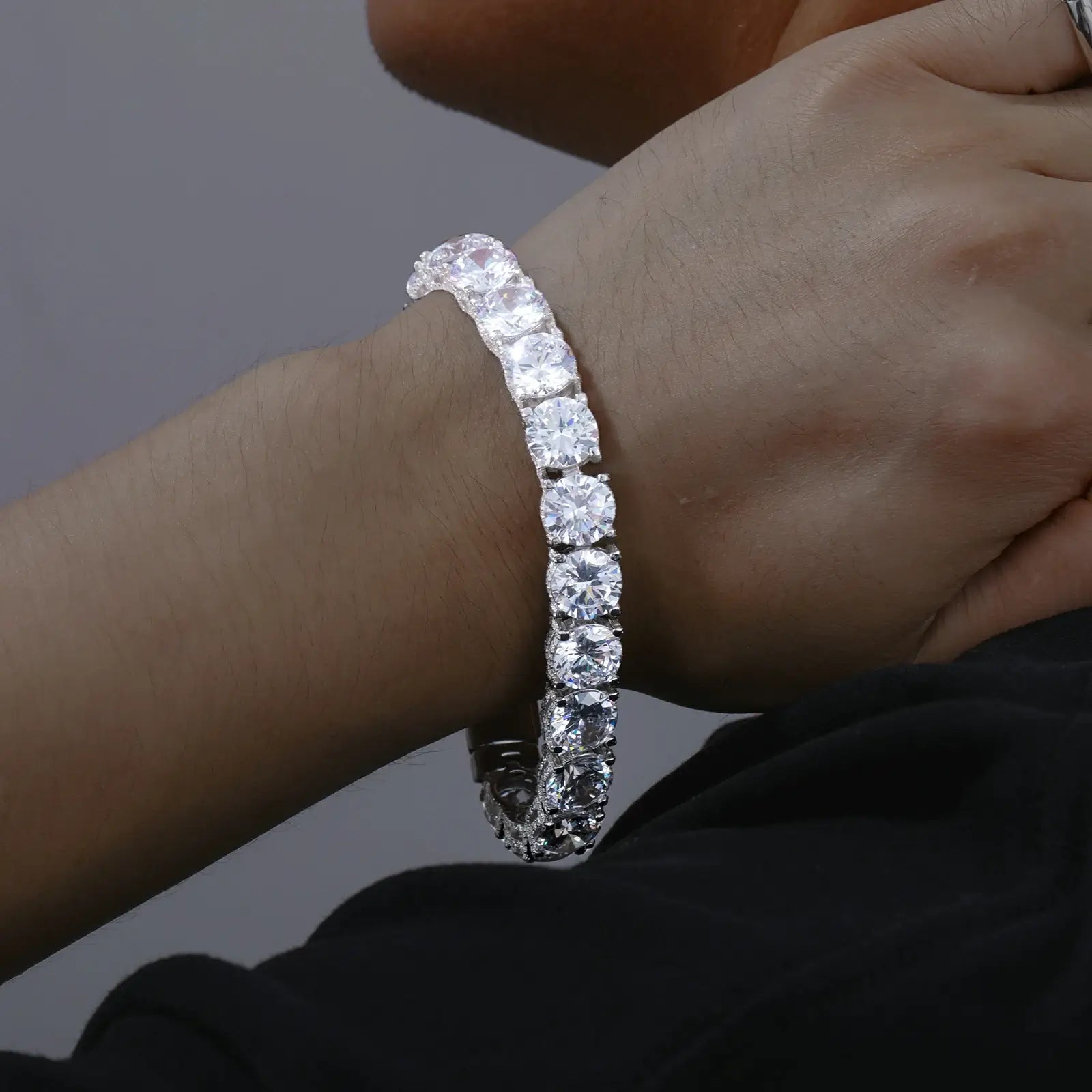 Male model wearing 10mm white gold 925 sterling silver moissanite iced out tennis bracelet — hypoallergenic waterproof luxury hip - hop jewelry