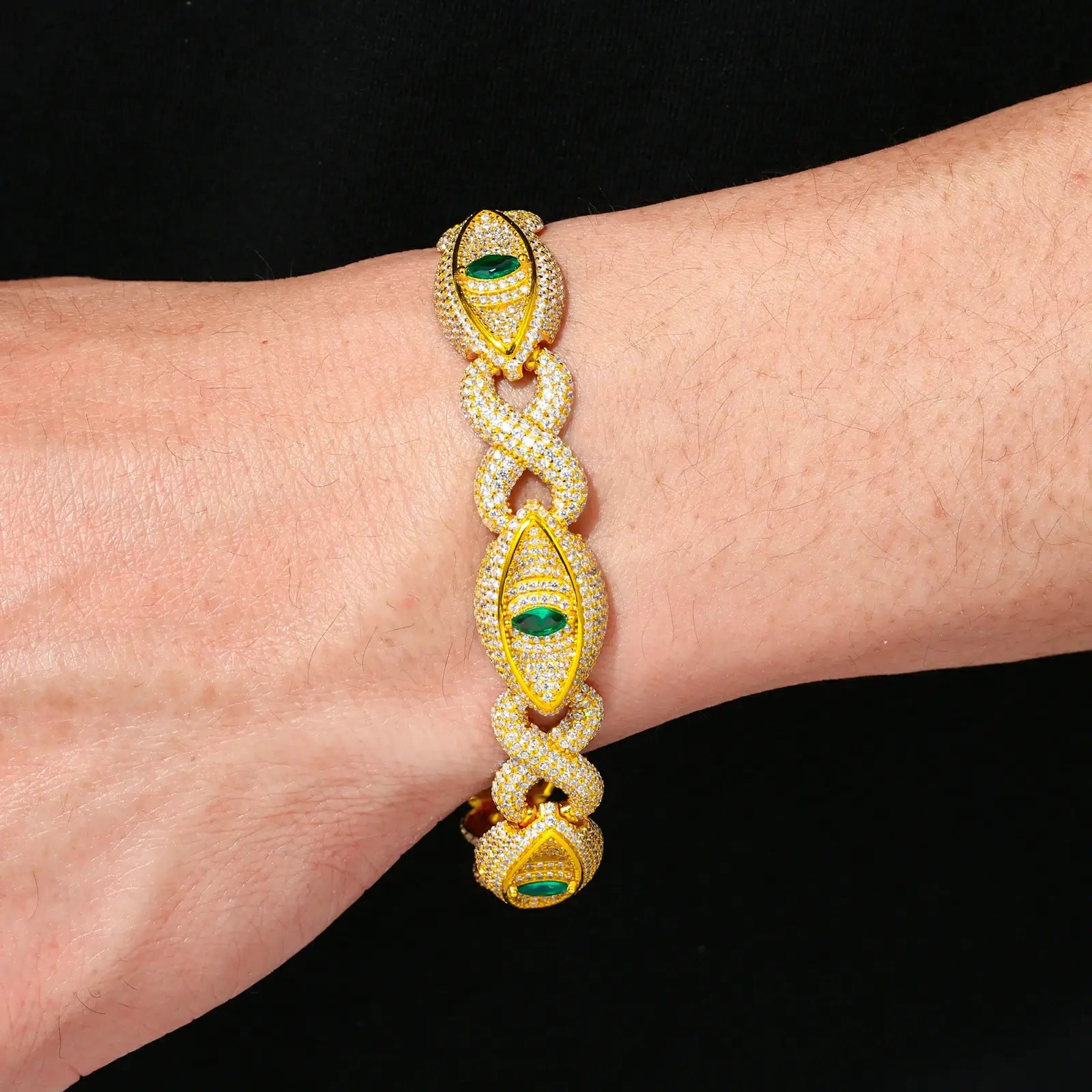 Male model wearing yellow gold 14mm 925 sterling silver moissanite infinity evil eye link bracelet — tarnish-resistant 925 silver, vivid moissanite fire, streetwear-ready evil eye motif
