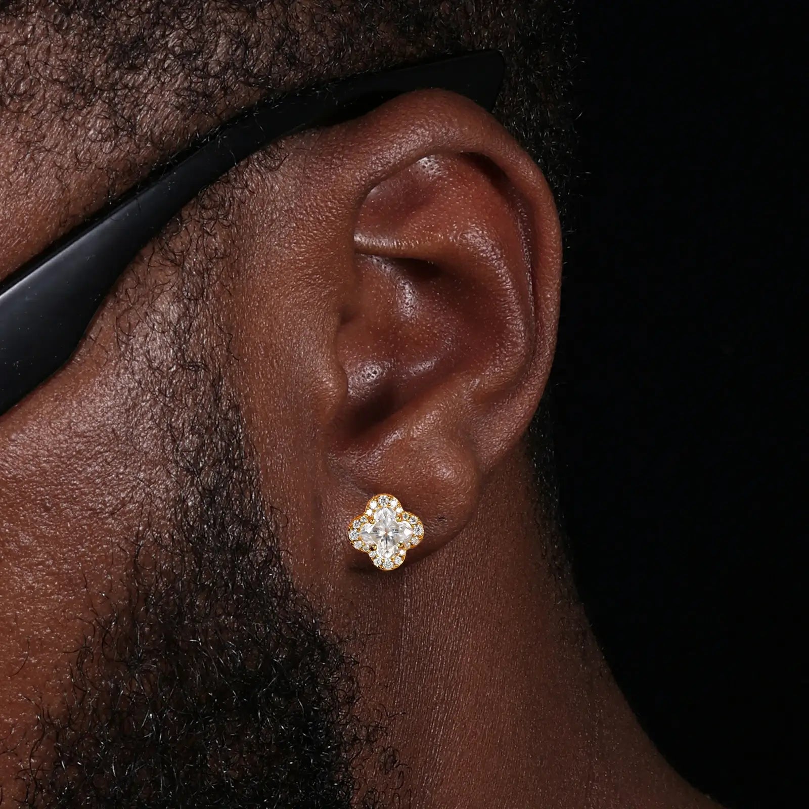 Male model wearing yellow gold 925 sterling silver lily cut moissanite four leaf clover stud earrings — tarnish-resistant 925 silver, bold clover design, moissanite for understated masculine glamour