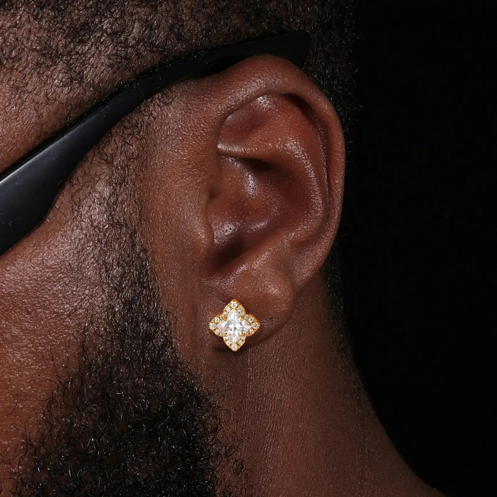 Male model wearing yellow gold 925 sterling silver lily cut moissanite star stud earrings — tarnish-resistant 925 silver, bold star design, moissanite for edgy masculine glamour