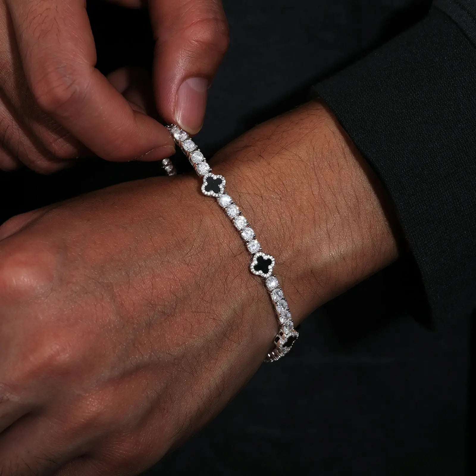 Model wearing 4mm 925 sterling silver moissanite tennis bracelet with four leaf clover agate — black outfit styling, everyday wearability, moissanite shine, hypoallergenic 925 silver