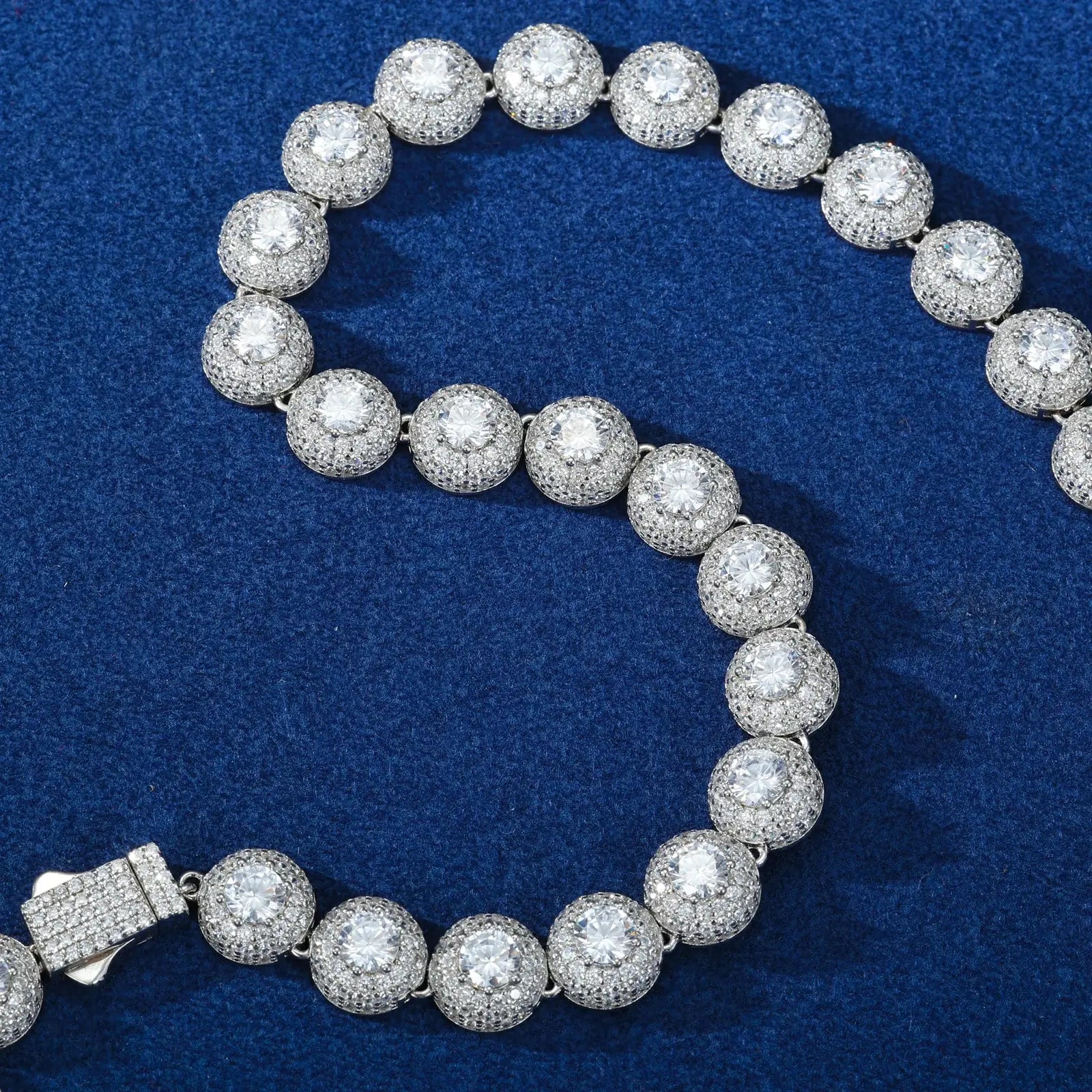 Close-up of white gold 10mm 925 sterling silver moissanite round halo tennis chain on blue background — showcases round halo moissanite detailing, 925 silver build quality