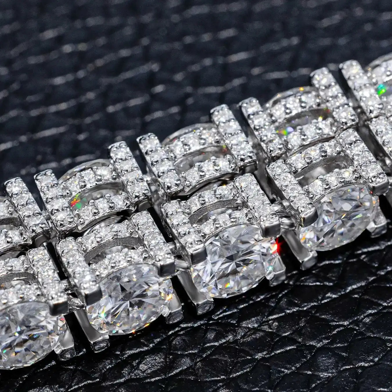 Side close-up of white gold 5mm 925 sterling silver moissanite full iced tennis bracelet on black table — showcases side moissanite detailing, 360° sparkle, 925 silver build quality