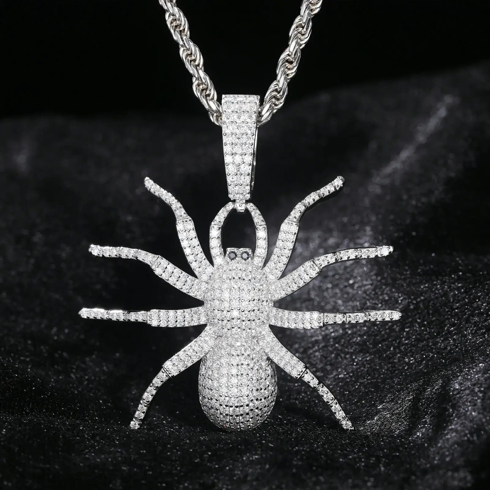 White gold 925 sterling silver moissanite spider pendant hanging on black table — showcasing eight-legged design, moissanite brilliance