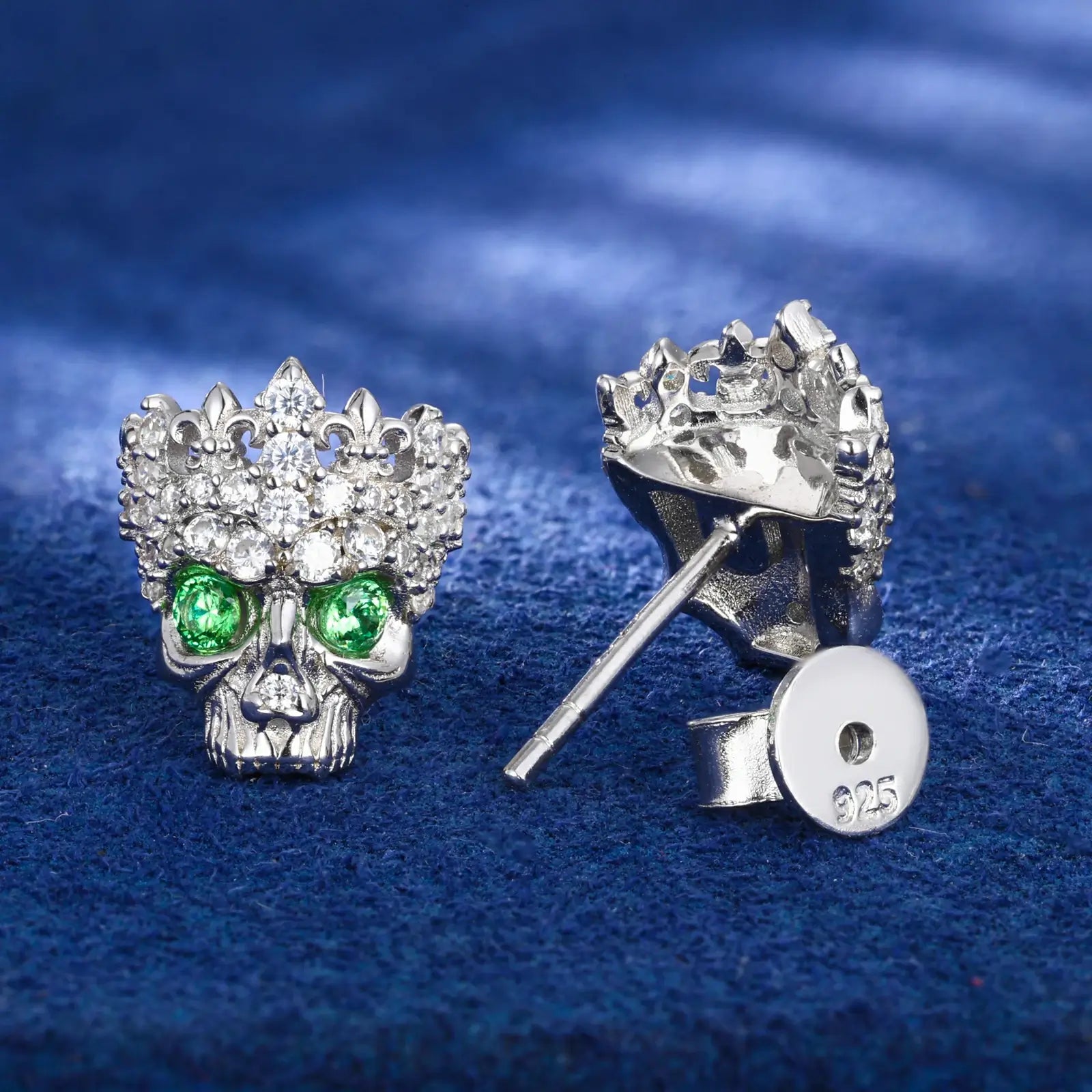 Back close-up of white gold 925 sterling silver moissanite Chrome Hearts crown skull stud earring on blue table — showcasing 925 silver post, secure backing, crown-skull design from behind with moissanite & zircon