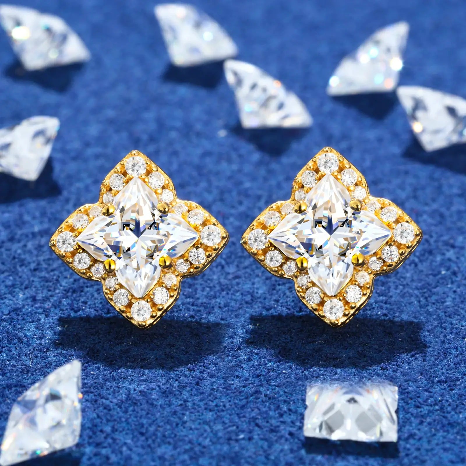 Yellow gold 925 sterling silver lily cut moissanite star stud earrings full display on blue table — showcasing geometric star design, moissanite sparkle, 925 silver craftsmanship