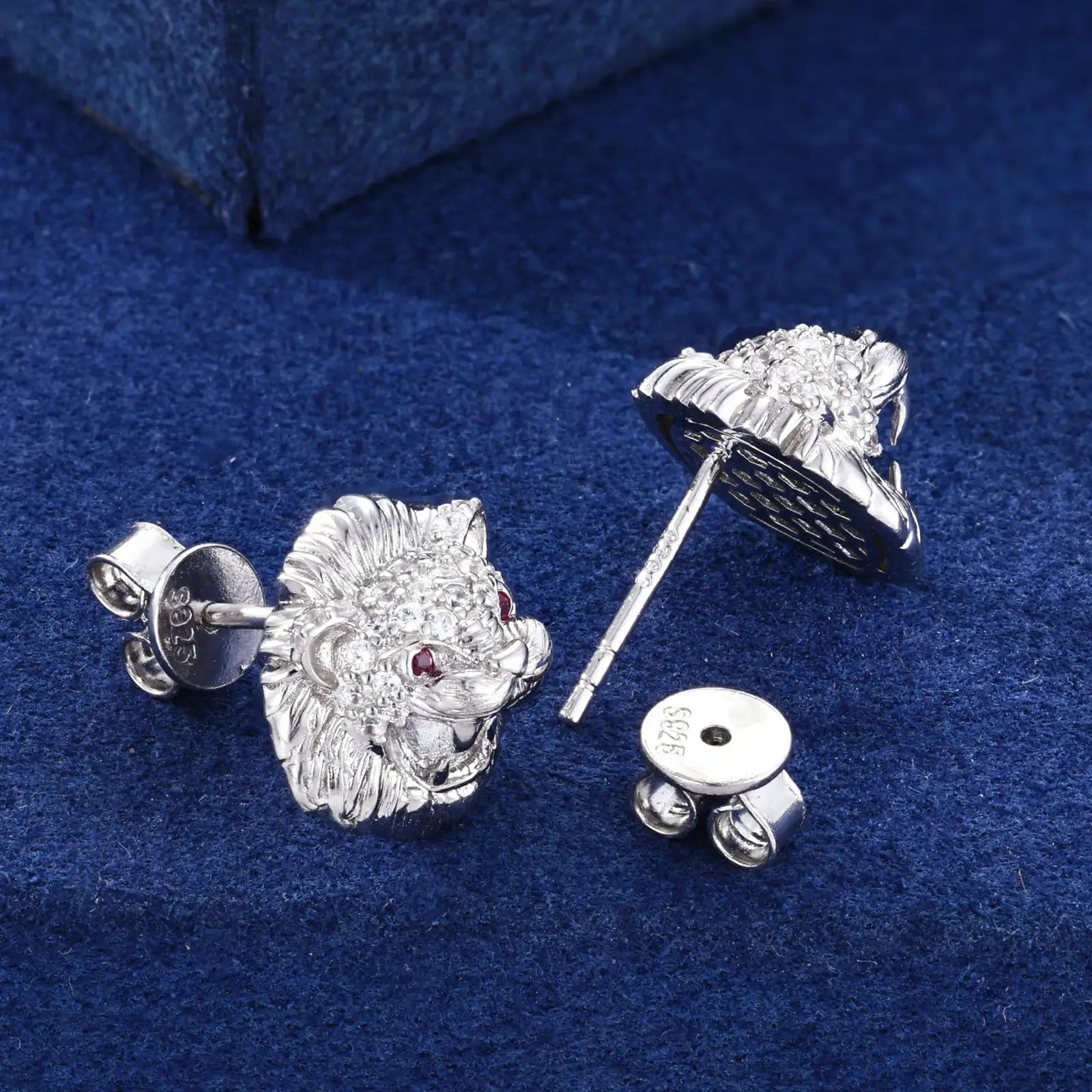 Back close-up of yellow gold 925 sterling silver moissanite little lion stud earring on blue table — showcasing 925 silver post, secure backing, lion design from behind