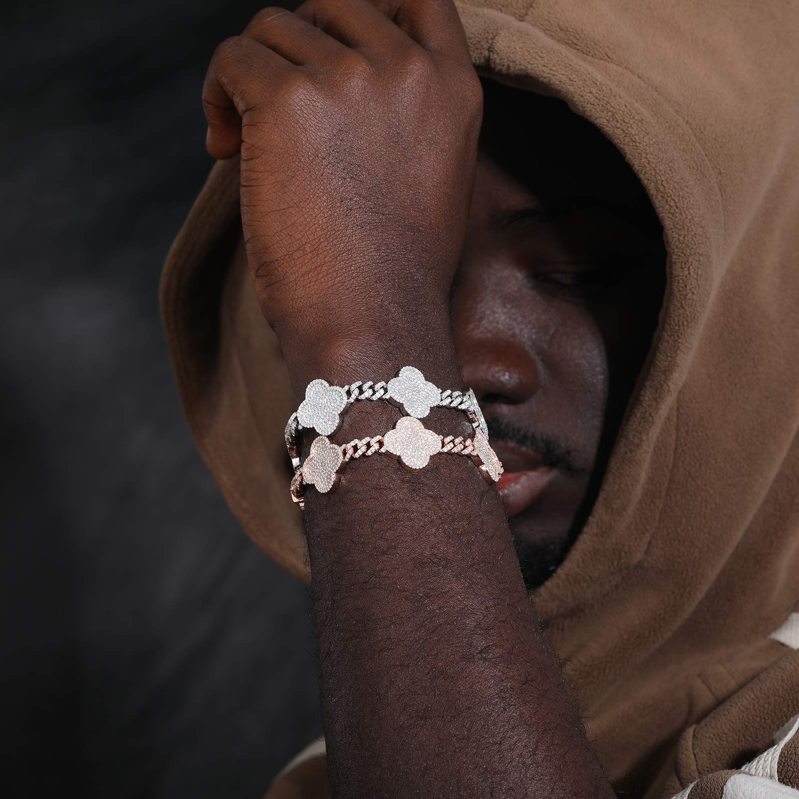 a-black-guy-is-wearing-two-four-leaf-clover-bracelet
