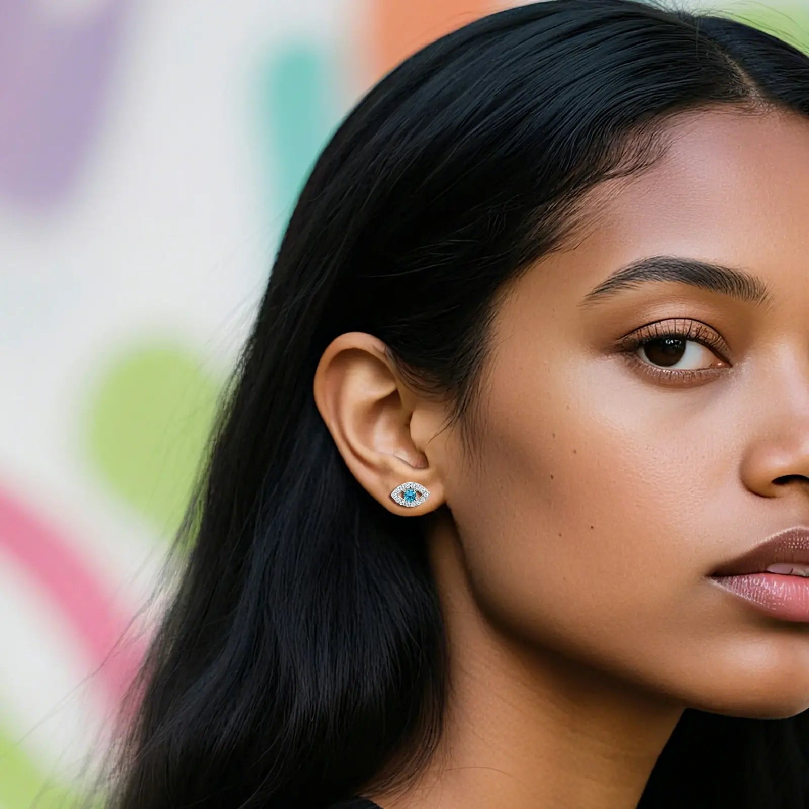 Black female model wearing S925 moissanite evil eye studs - cerulean blue center with VVS diamond halo | Modern talisman earrings