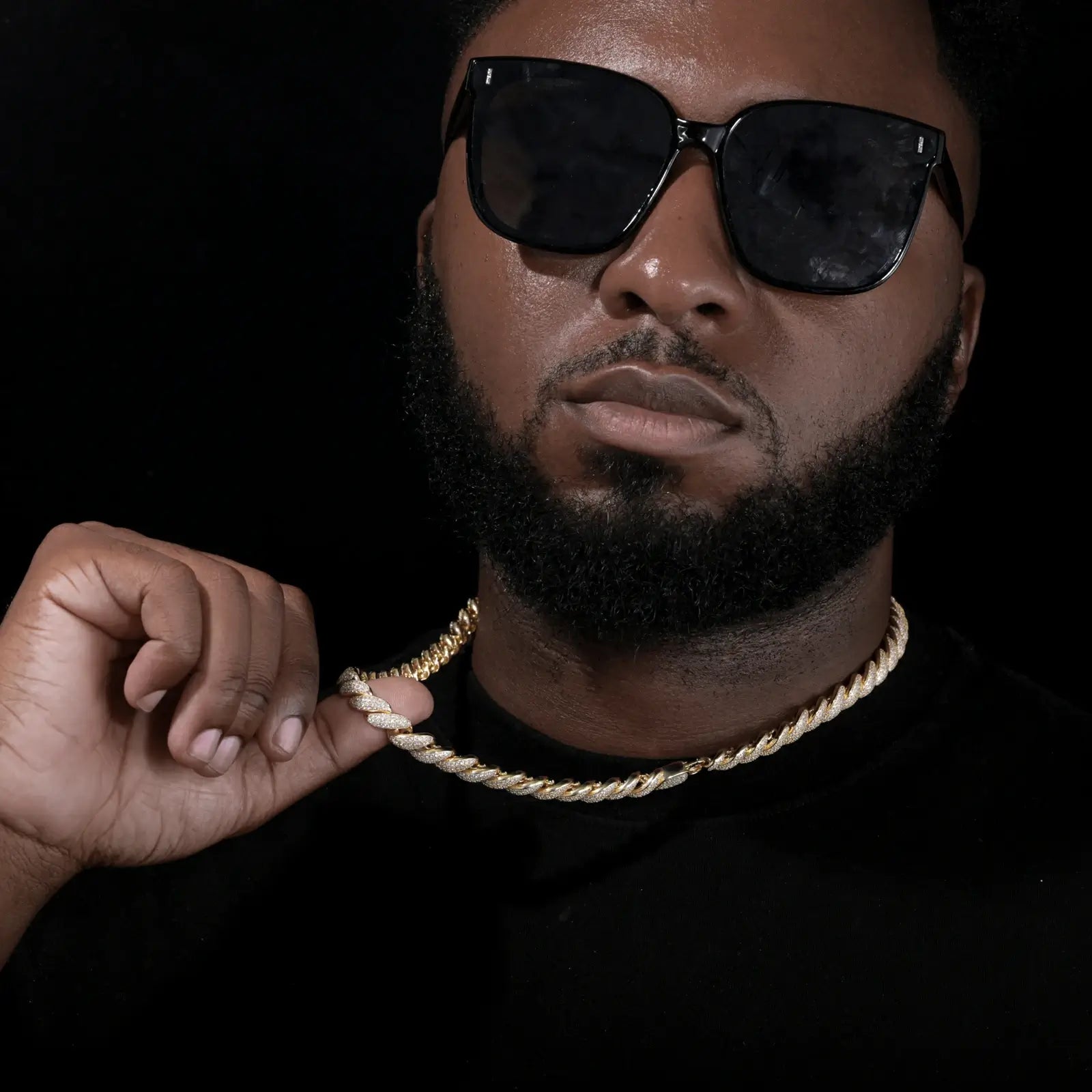 Stylish black man in tailored suit wearing iced-out rope chain - hypoallergenic S925 core for sensitive skin