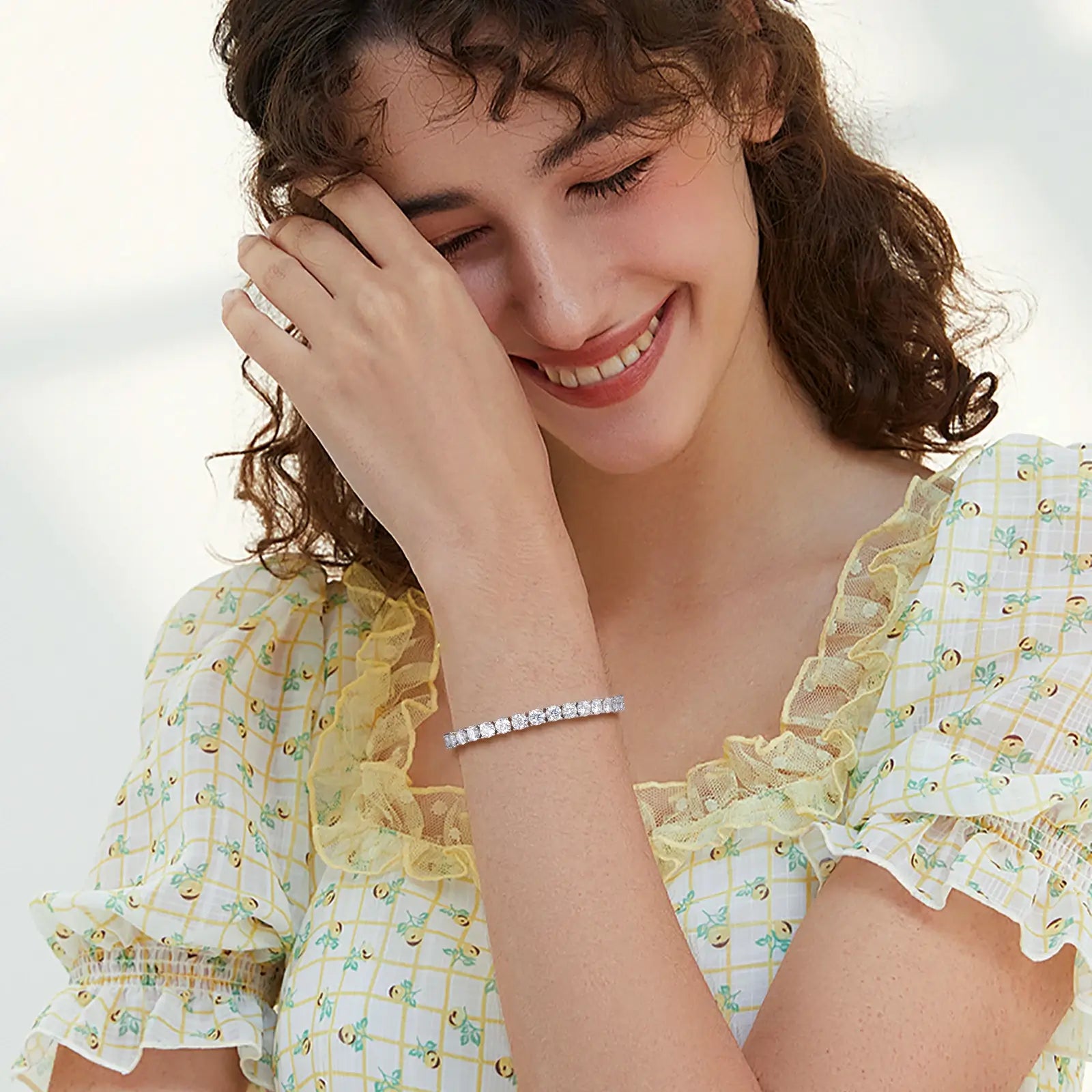 Female model closeup: 4mm iced-out bracelet with spring clasp - S925 silver stones shining at brunch event | Stackable jewelry