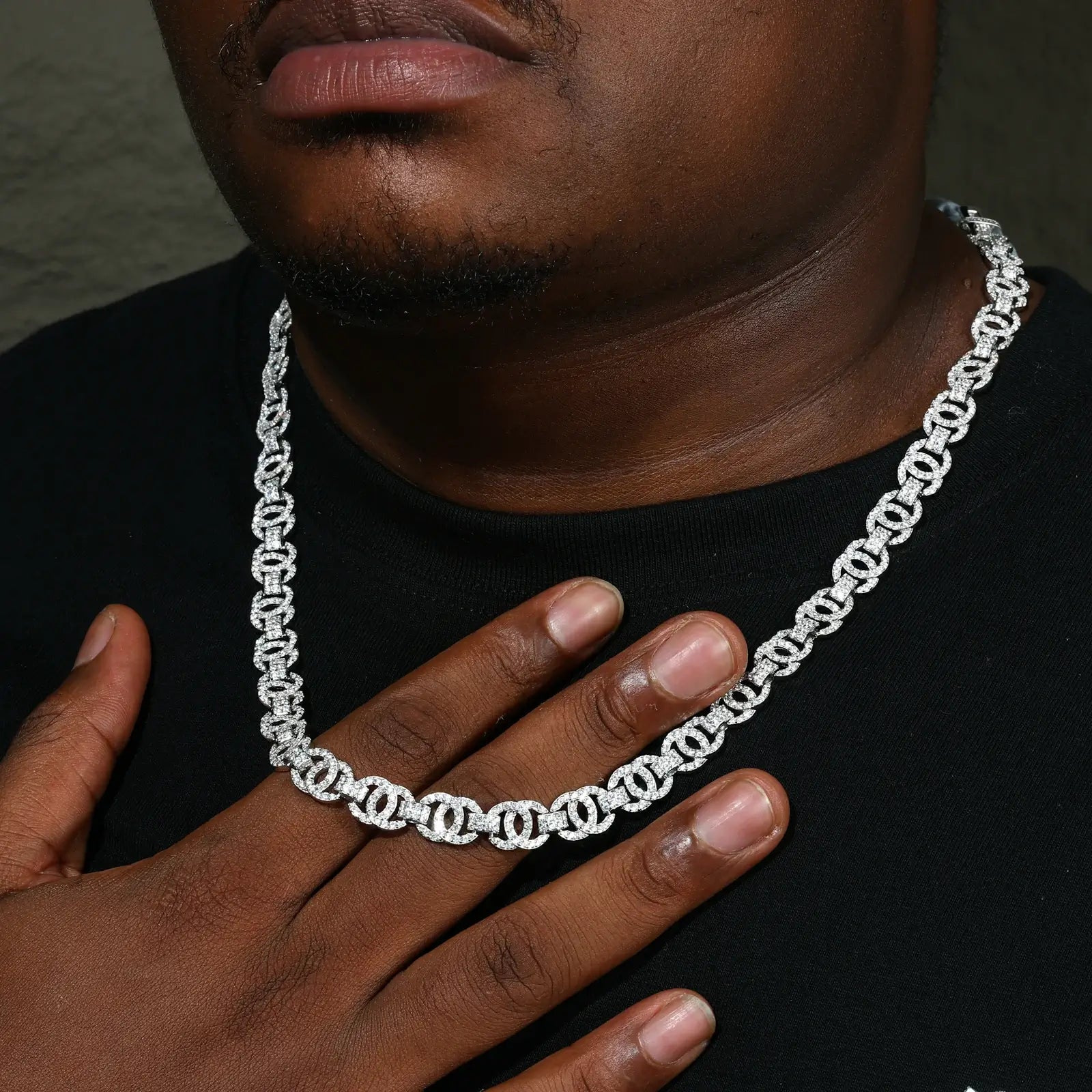 Closeup of 10mm white gold plated Cuban chain on African American male model - hypoallergenic S925 silver with moissanite sparkle