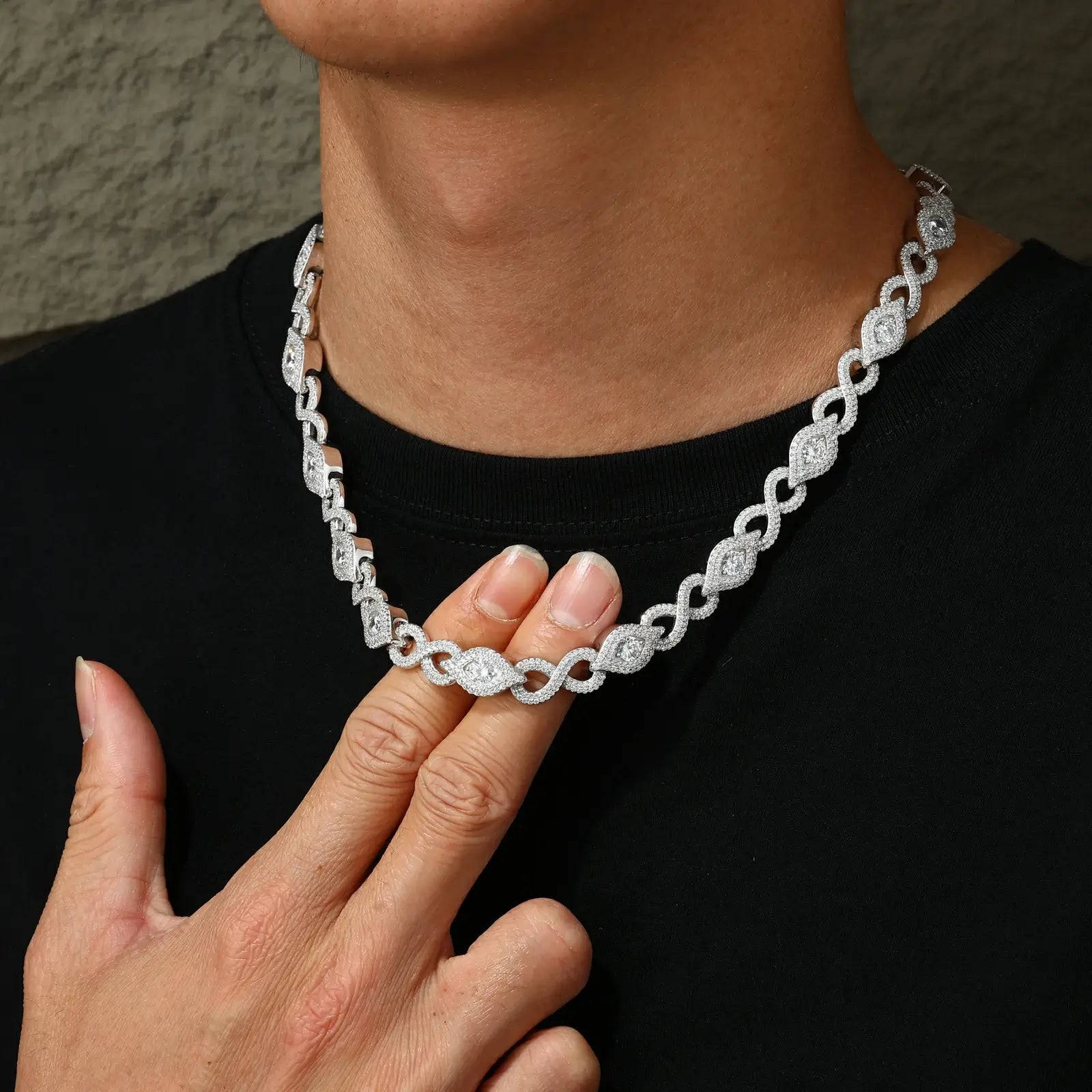 Macro shot of screw clasp mechanism on 10mm Evil Eye chain - anti-tarnish white gold plating over S925 silver shown on black male model's neck