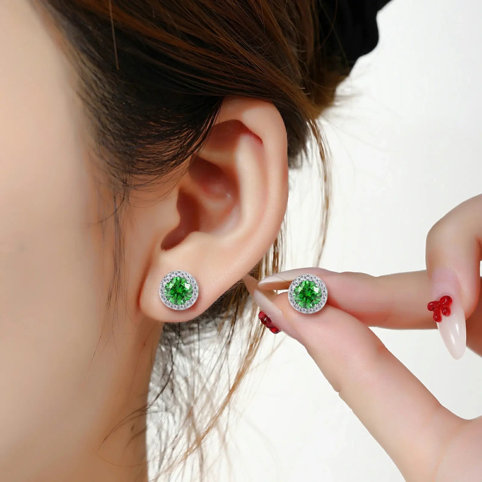 Hypoallergenic moissanite stud earrings on woman - Vivid green center stone with micropave halo | Everyday luxury jewelry for work