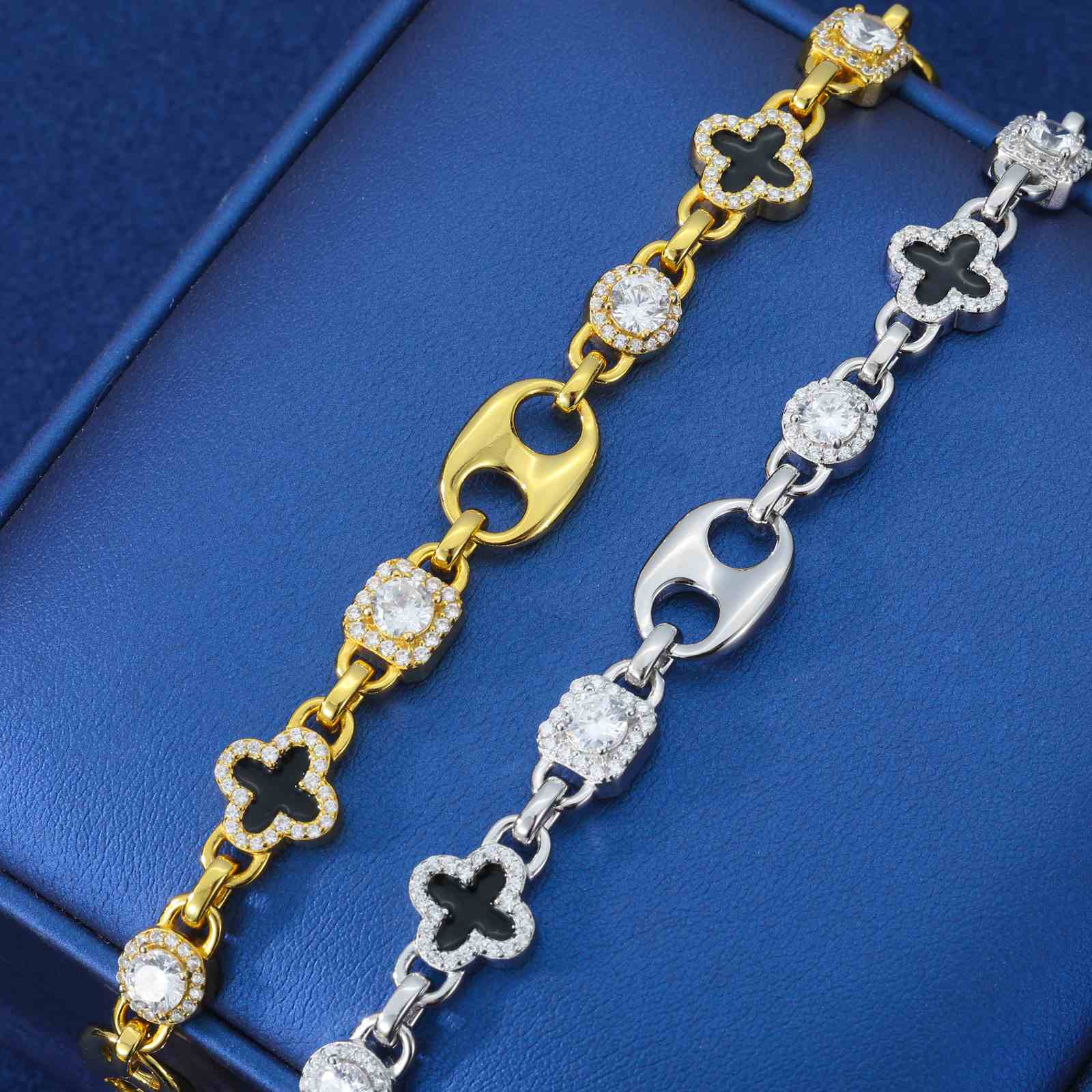 Side-by-side comparison of gold and white gold clover bracelets, highlighting enamel color vibrancy and moissanite brilliance