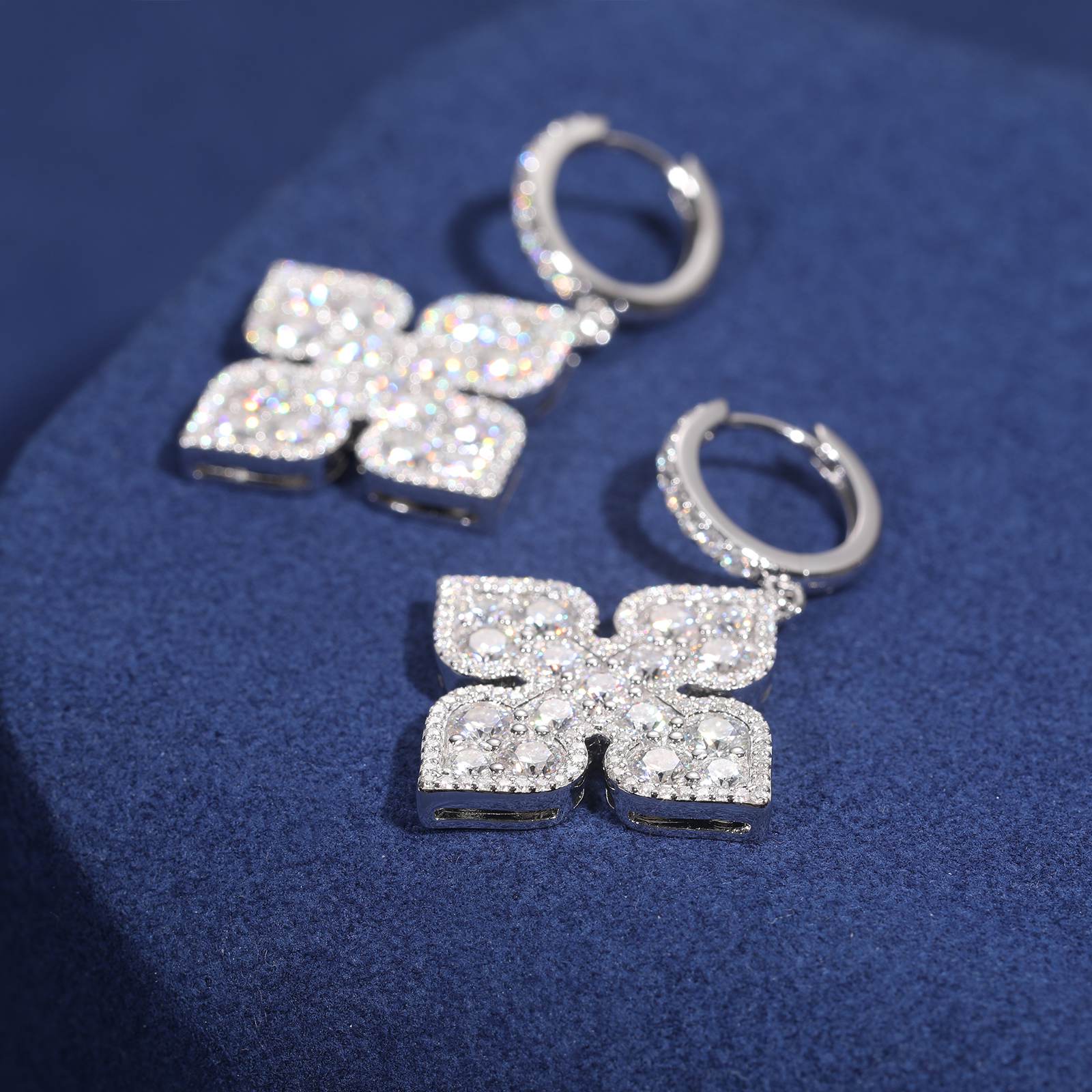 Athletic woman in gym wearing peach clover drop earrings during workout, demonstrating military-grade 24K gold’s resistance to sweat and friction. Earrings stay secure with patented spring clasp during deadlifts and boxing sessions