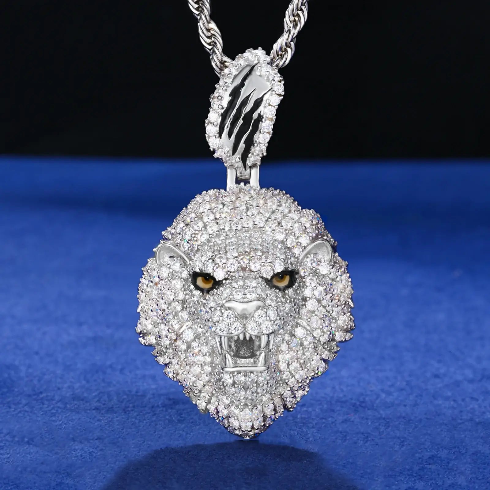 925 sterling silver micro pave lion head pendant hanging on blue table - detailed mane with moissanite stones and fierce expression