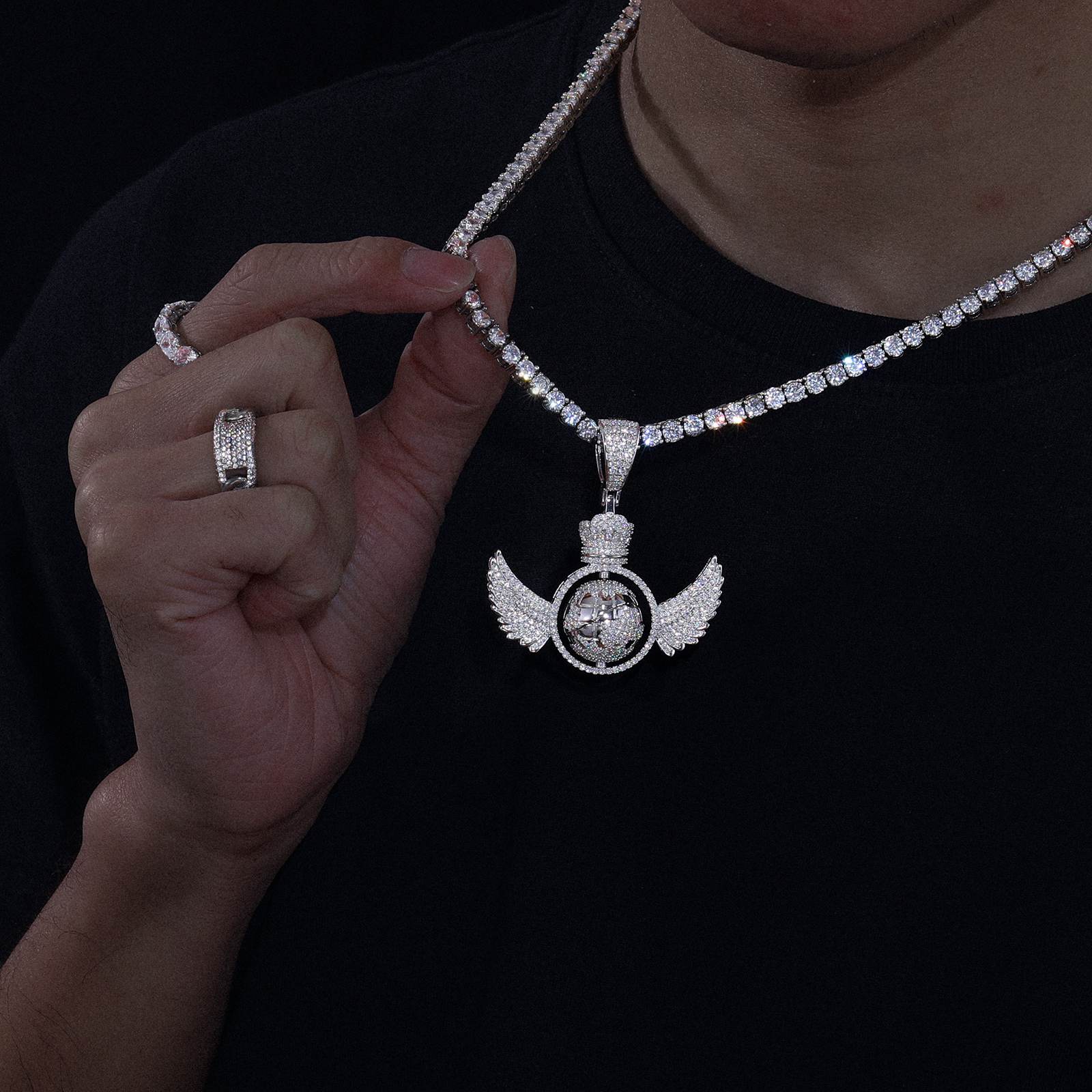 African American executive wearing spinning earth pendant on diamond tennis chain - lab-grown moissanite continents refracting 2.65 RI | Boardroom statement
