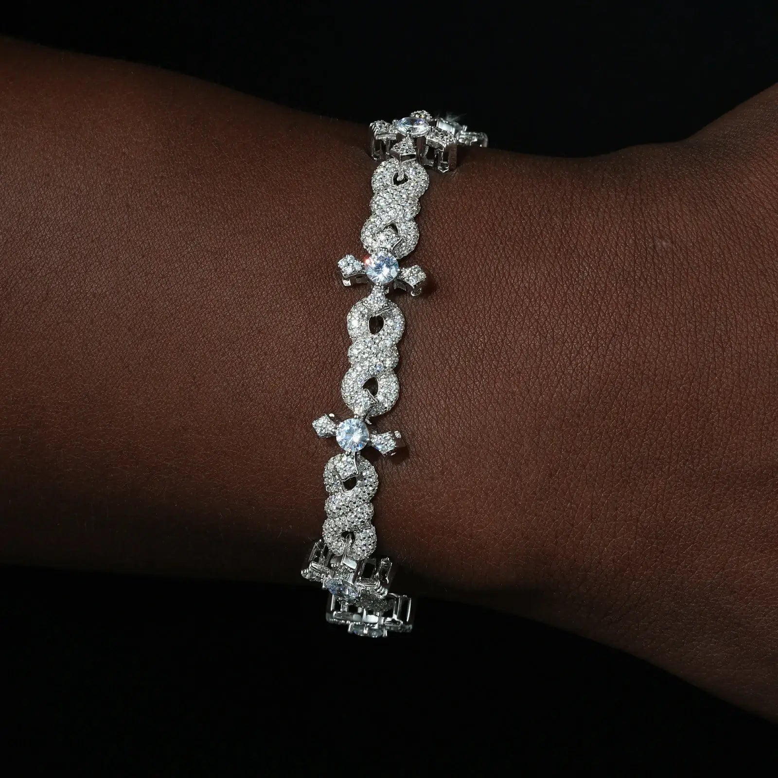 Caucasian man wearing 13mm white gold bracelet - infinity symbols entwined with crosses in S925 silver | Waterproof spiritual armor jewelry