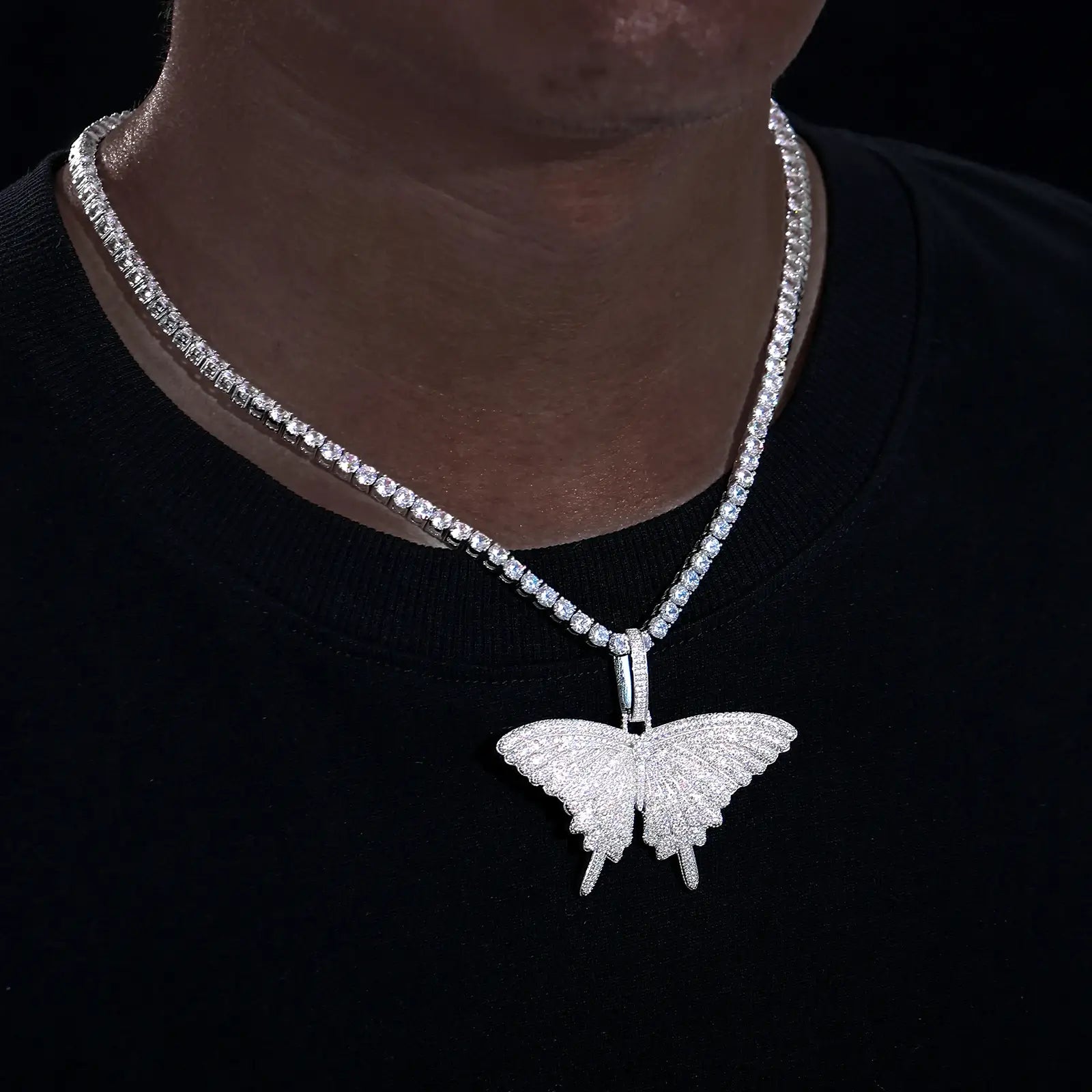 African American man styling moissanite butterfly pendant - S925 silver pavé wings on tennis chain | Tarnish-proof spiritual jewelry