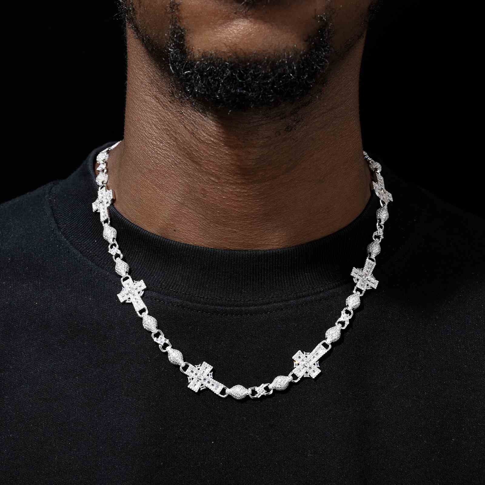 Male model wearing the white gold-plated Celtic Cross Chain layered over a black hoodie, highlighting urban fashion versatility