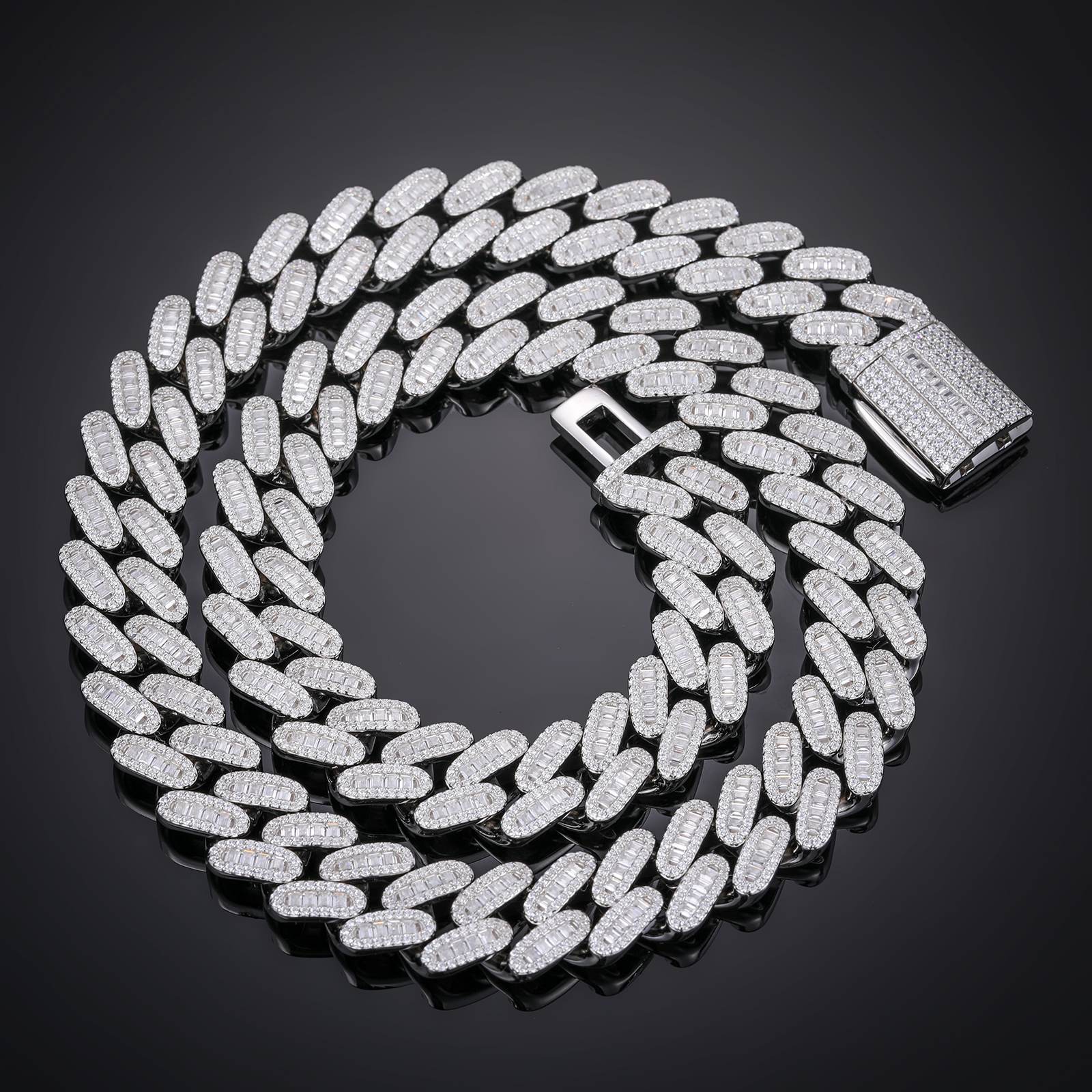14mm S925 Cuban Chain on black marble, showcasing single-row baguette moissanites under dramatic lighting for luxury streetwear