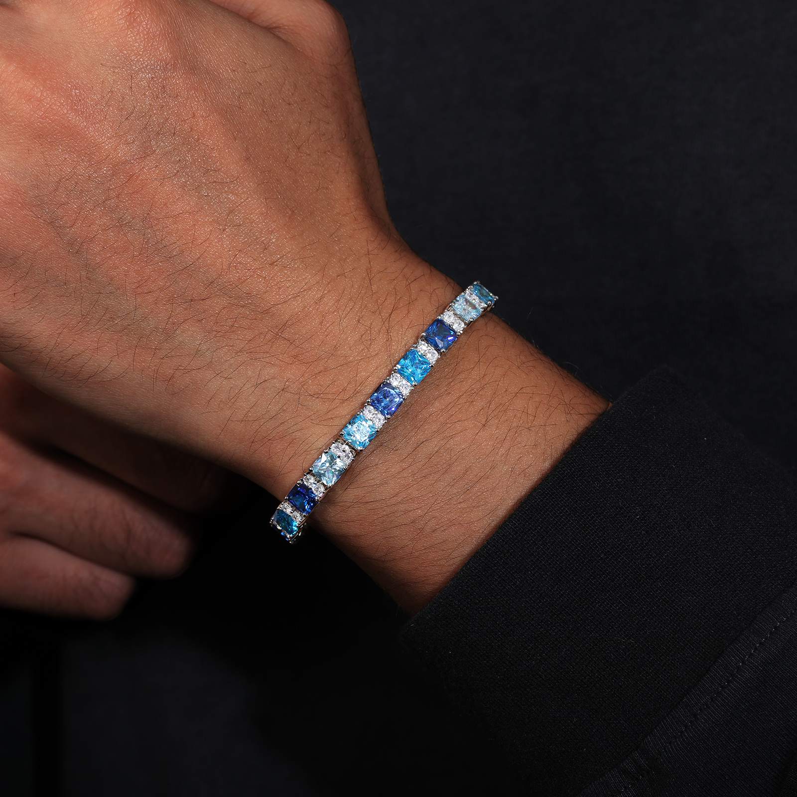 Stylish female model wearing the 6.5mm S925 sterling silver Asscher-cut tennis bracelet with gradient blue diamonds, styled with urban streetwear for a bold hip-hop aesthetic