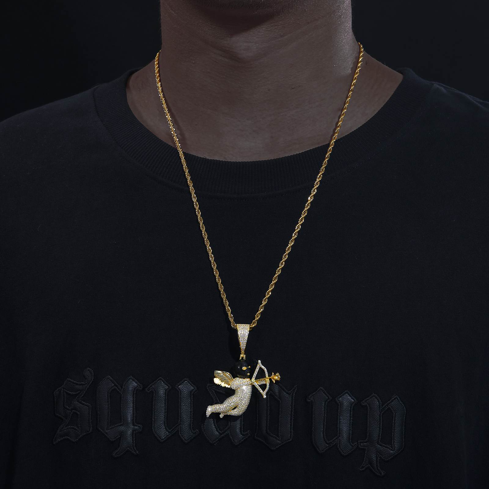 Urban influencer wearing gold Cupid arrow pendant on twisted chain - lab-grown moissanite outshining diamonds | Salt-spray tested waterproof armor