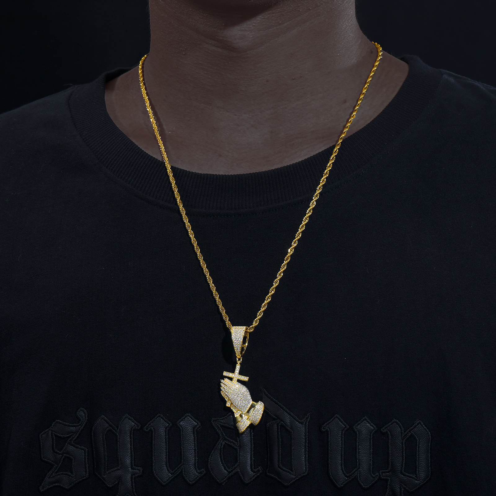 Street influencer wearing gold pray hand cross on twisted chain - salt-spray tested waterproof core | Street-to-chapel versatility