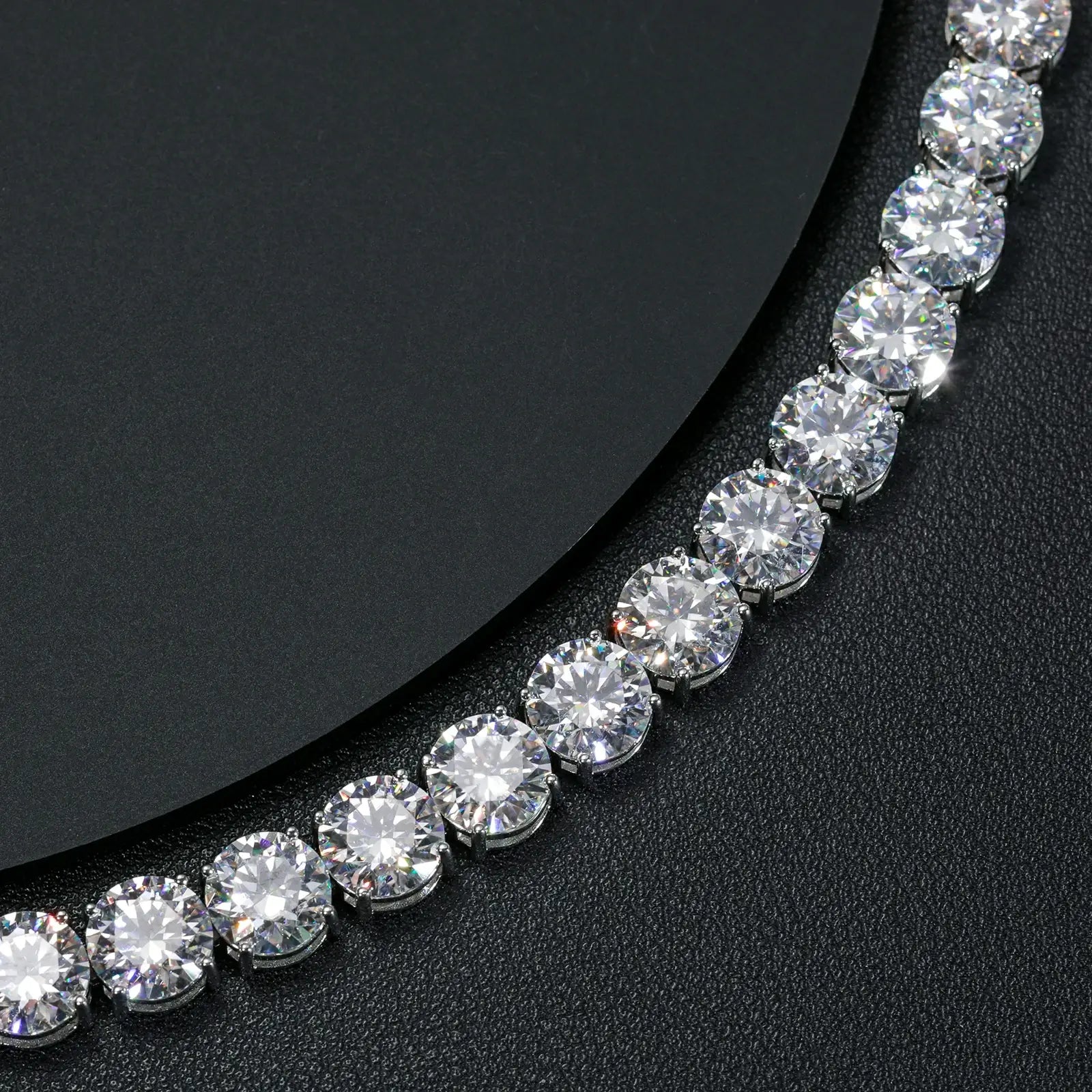 Detailed close-up of 10mm white gold moissanite tennis bracelet chain links, showcasing secure clasp and articulated construction.