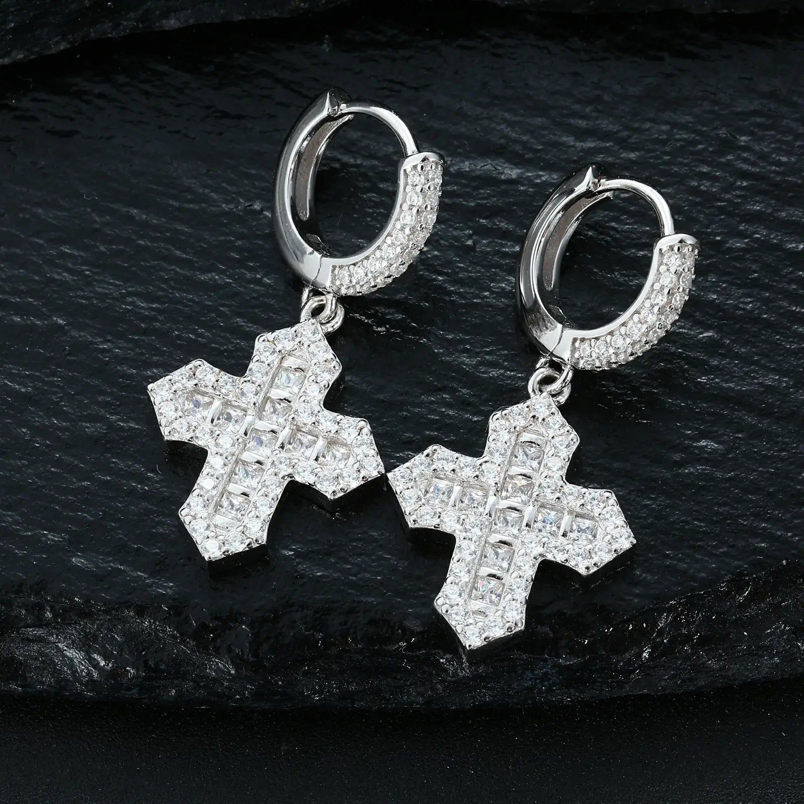 White gold cross drop earrings on black surface - S925 silver with princess cut center stone | Waterproof faith-based jewelry