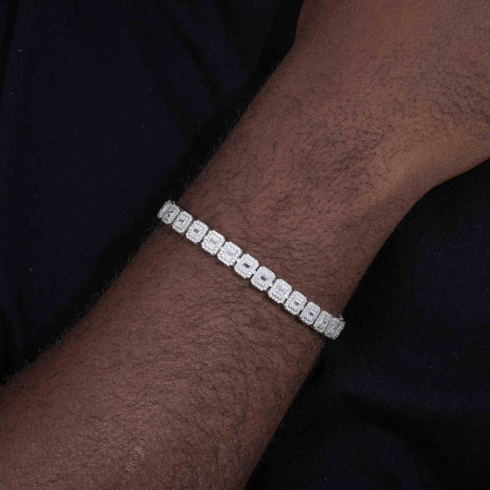 Male model wearing white gold-plated bracelet at a block party, highlighting seamless integration with raw urban aesthetics.