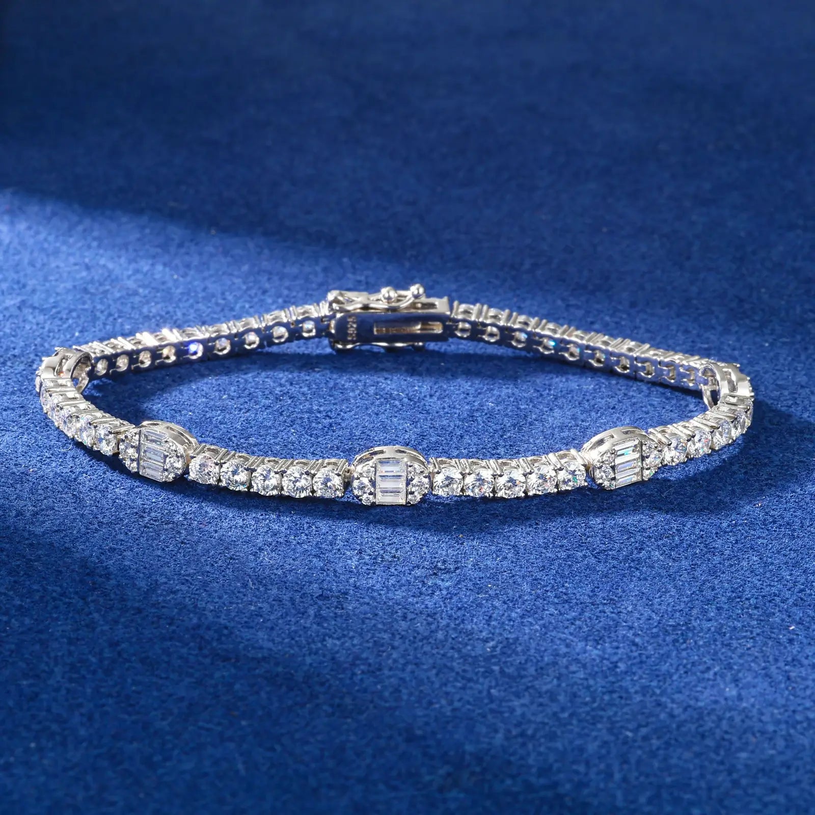 5.5mm white gold pills bracelet on marble table - geometric capsule links beside luxury watch and sunglasses