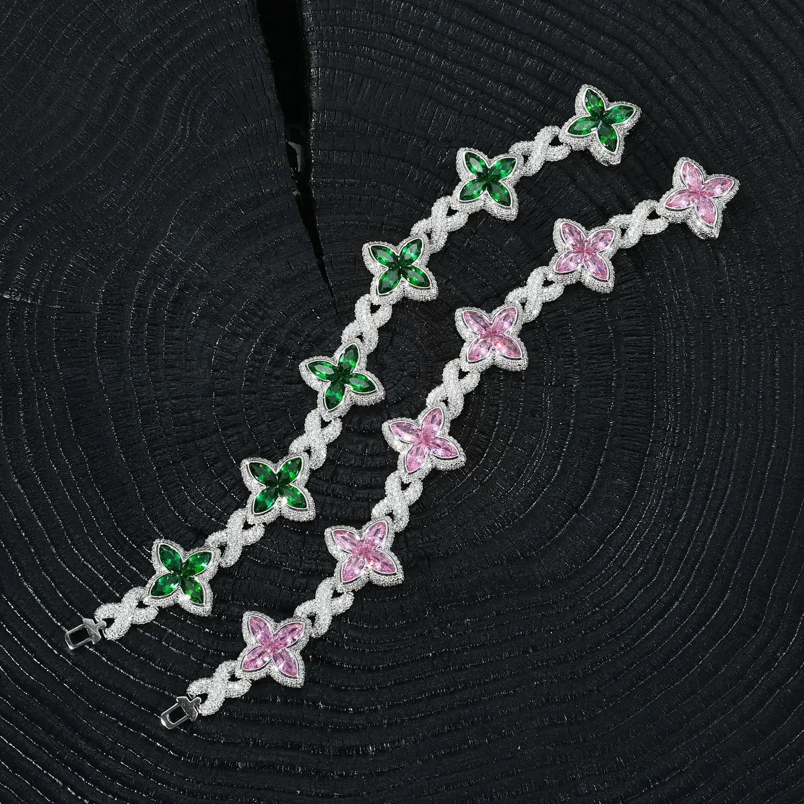 Pink & green clover bracelet on black table - 21mm S925 infinity design with colorful zircon centers | Tarnish-proof luxury